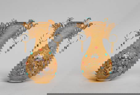 Two Chinese Enameled Gold on Silver Vases: Either of pear shape rising to a flared neck with two loop handles issuing flowers, the reticulated gold-on-silver body enameled with blossoming and budding flowers, inset with stone, the bottom marke