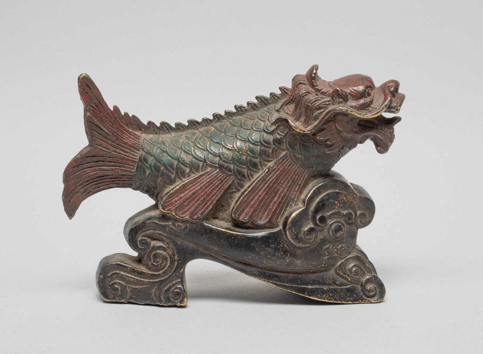 Chinese Painted Bronze Sculpture: Cast as a mythical dragon-fish jumping out of scrolling clouds. Approx. 6.2*4.4*2 inch. The Estate of the Store Closed Sale, Palm Springs, CA.