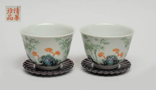 Pair Chinese Export Porcelain Cups: Two porcelain cups exterior decorated with bamboo, lingzhi and rocks, the bottom marked with four characters in copper-red, with wood carved chrysanthemum form saucers. Approx. 3.6*2.4 inch (cup size)