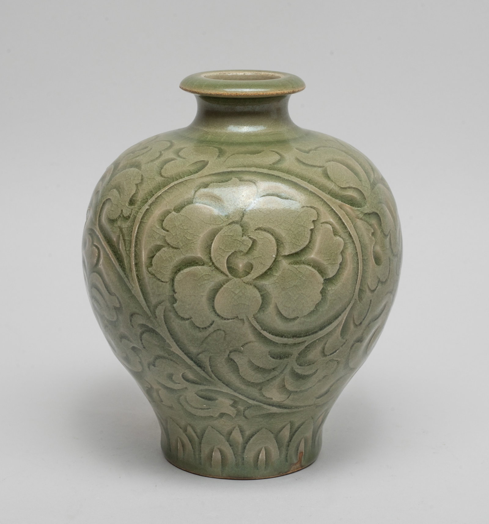 Chinese Export Yaochou Porcelain Vase: Of tapered ovoid form, the exterior carved with undulating lotus scrolls above a band of overlapping leaves, covered overall with crackled olive-green glaze. Approx. 6*5 inch.