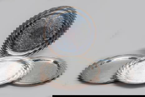 Set Silver Plated Chargers: Set of four silver-plated chargers, carved with exquisite floral motif, one plate underside marked INTERNATIONAL SILVER CO., one marked ROGERS, and the other two marked SILVERPLATE. Approx. 15inch D (