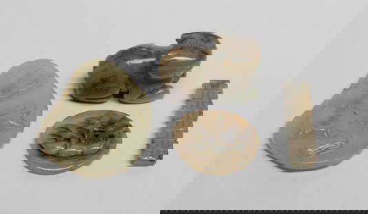 Set Chinese Export Jade Toggles: Set of four Chinese jade toggles, one carved of recumbent tiger form, one carved with C-shaped scrolls, the other two carved with lotus bloom, root and leaf. Approx. 2.2*1.7 inch (largest).