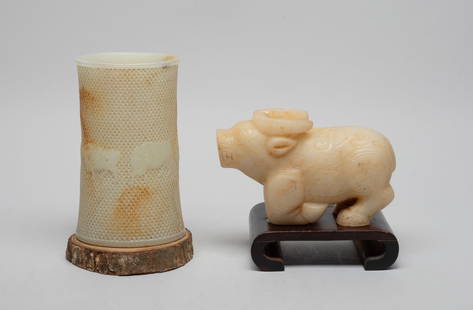 Chinese Export Glass Sculptures: Including a brush pot of gently waisted cylindrical form, carved with five buffalo against a background suffused with raised bosses, and a horned beast sculpture in recumbent pose, each with a wood st