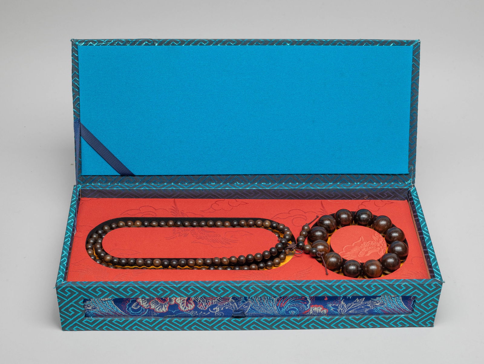 South Asian Agarwood Prayer Beads: Including a long agarwood bead necklace and an agarwood bead bracelet, with box. Approx. 90 gram (total wood weight), 33 inch L (necklace size).