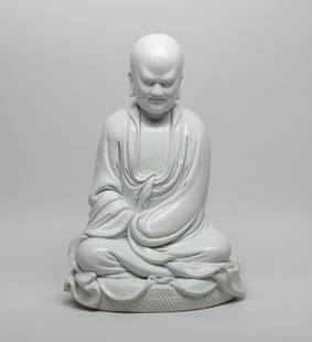 Estate Chinese Blanc De Porcelain Buddha: Modeled as Buddha seated on a futon, wearing a long flowing robe open at the chest, the exterior covered with even white glaze, the back with a gourd-shaped seal. Approx. 13.6*9.2*7.5 inch.