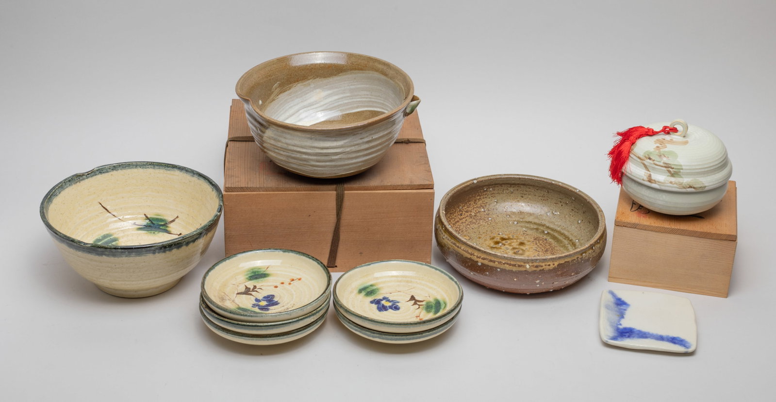 Japanese Taisho Stoneware Pieces: Large group of Japanese Taisho stoneware bowls and dishes, with two boxes. Size varies.