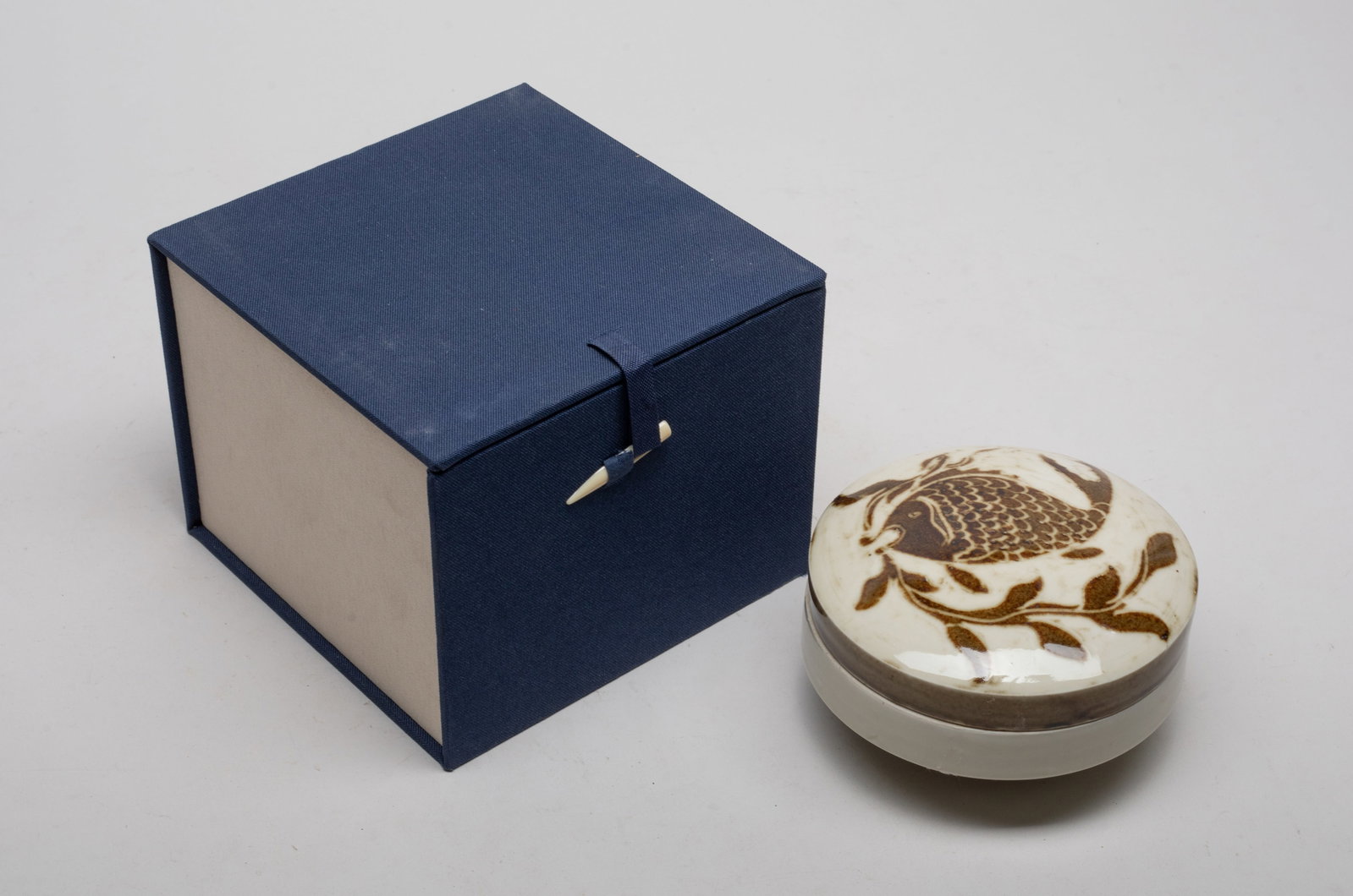 Estate Chinese Porcelain Box: The covered box top painted with a fish holding a leafy stem in mouth in brown color on creamy glazed background, with box. Approx. 4.5*2.7 inch (w/o box).