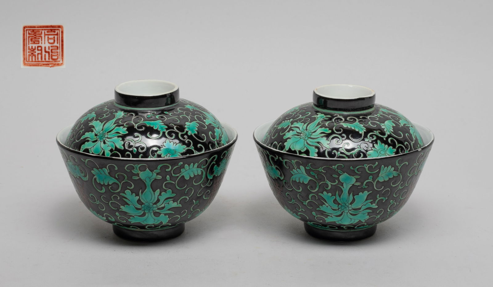 Estate Chinese Export Porcelain Tea Cups: The tea cup and lid exterior decorated with turquoise-color lotus scrolls interspersed with bats and shou characters on black glazed background, the lid center and the cup bottom with copper-red seal