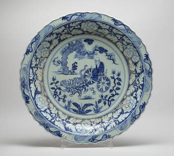 Large Chinese Export Porcelain Charger: The charger interior centre painted with an old man sitting on a cart leading by two beasts, among flowers under a pine tree, the sides with a band of stylized flowers, the exterior with a band of pet