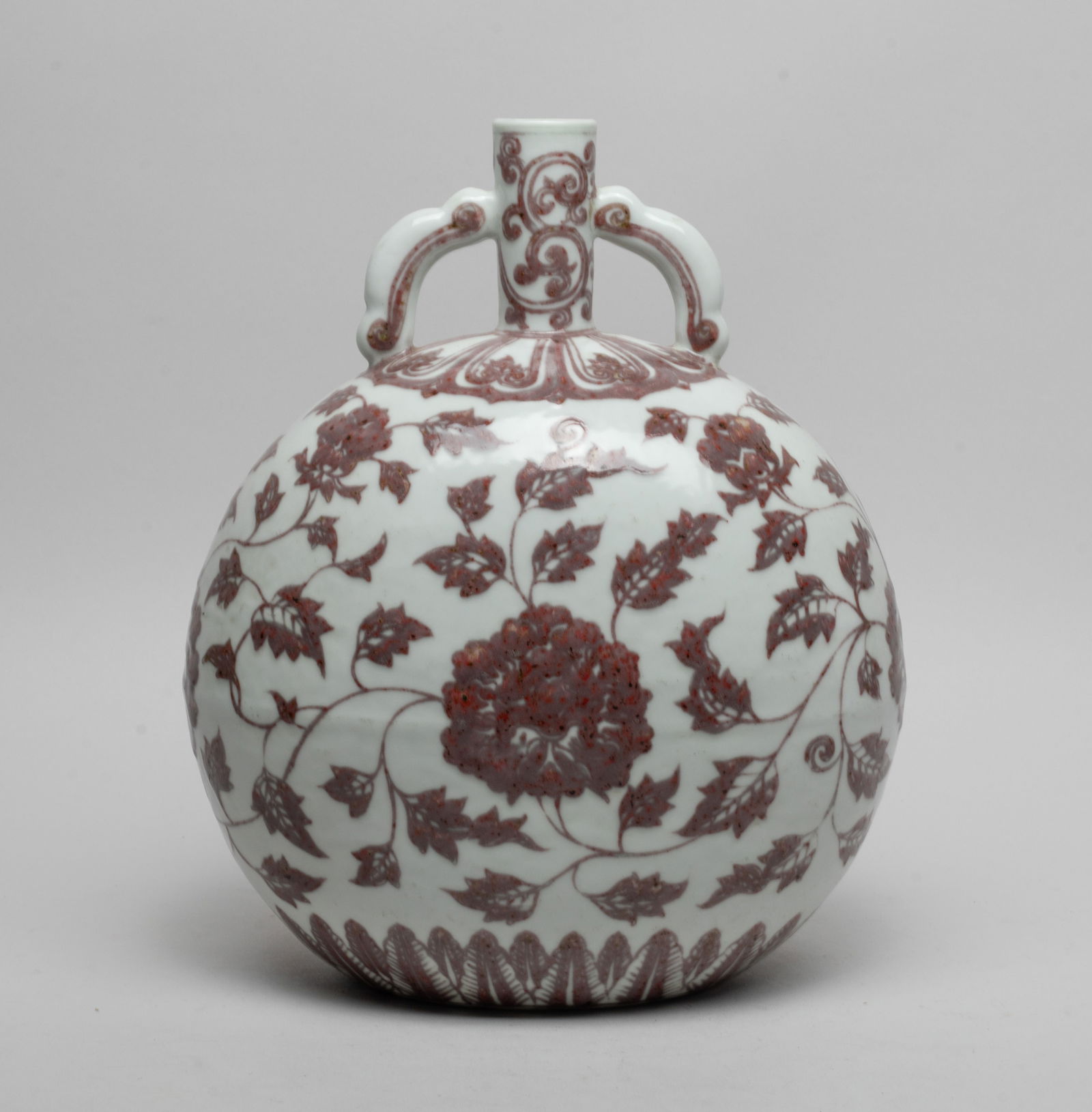 Chinese Export Porcelain Cabinet Vase: The rounded body painted with undulating leafy lotus sprays between bands of petals and leaves in copper red color, with a cylindrical neck with a pair of handles. Approx. 10.3*8.6*5.6 inch.