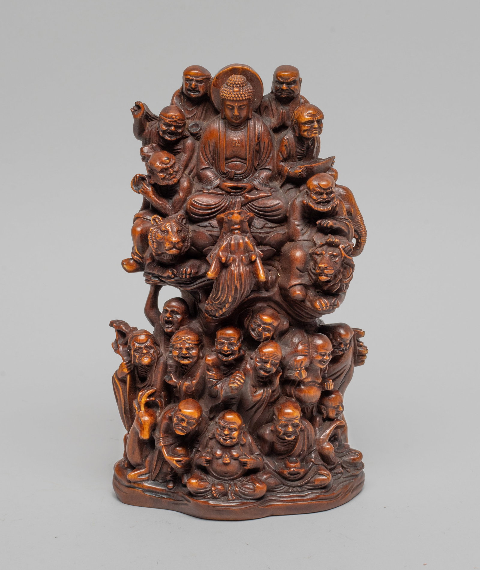 Estate Chinese Export Boxwood Like Sculpture: Expertly carved with the Eighteen Luohans, meticulously depicted with their attributes, riding upon waves or various mythical beasts, surrounding a seated Buddha at the upper centre, dressed in a loos