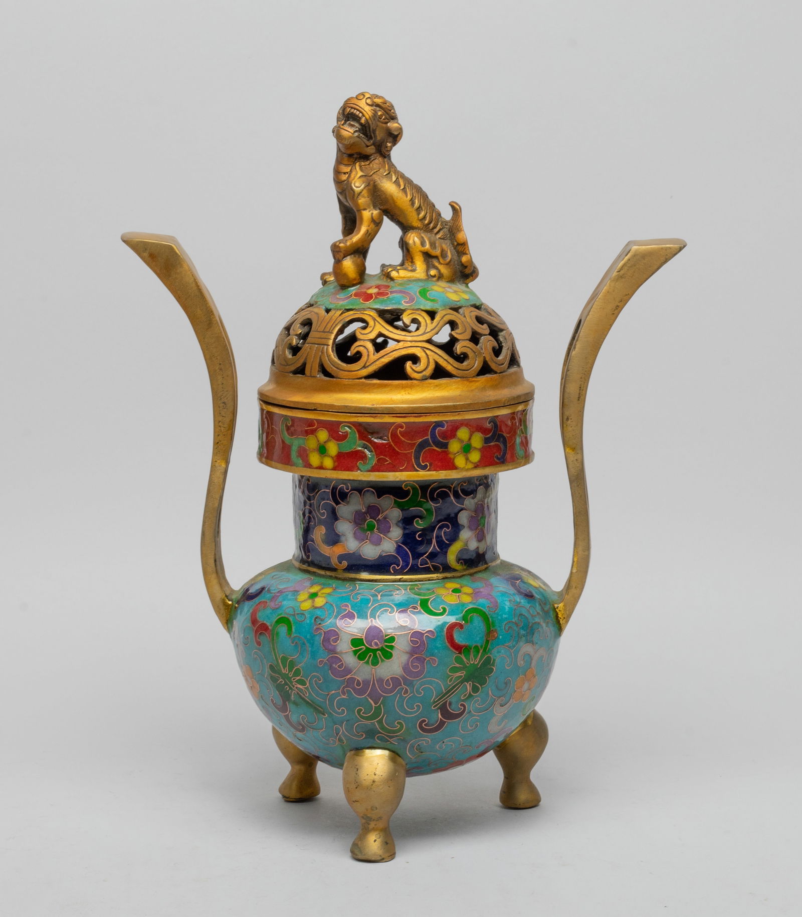 Tall Chinese Cloisonne Censer: The ovoid body rising to cylindrical neck and mouth with a pair of tall upright handles, all supported on three cabriole legs, enameled with flower scrolls on turquoise- blue and red background, the o