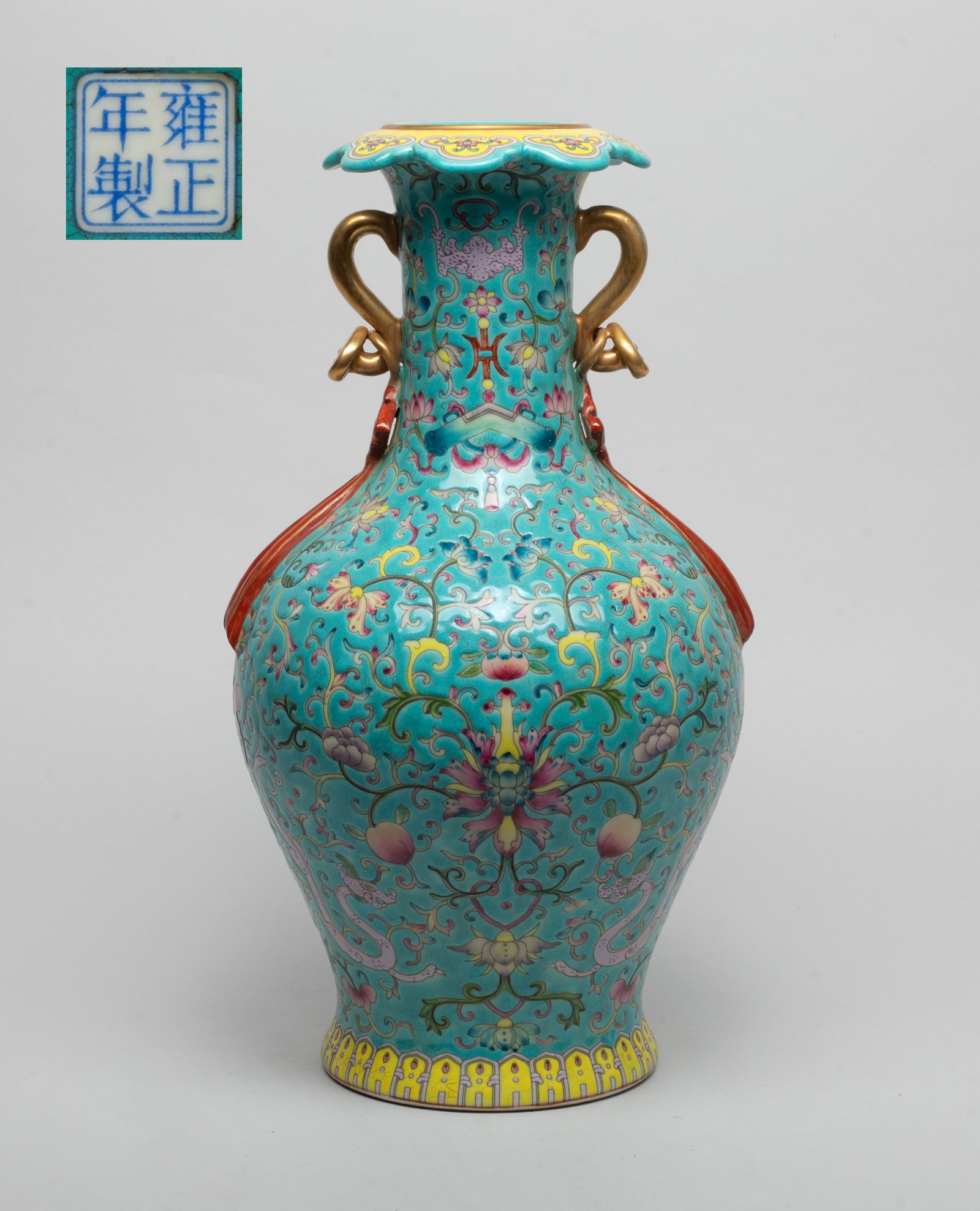 Tall Chinese Export Porcelain Vase: The vase exterior enameled and painted with dense leafy foliage issuing lotus and peaches, interspersed with dragons, bats and instruments, all against crackled turquoise background, flanked by a pair