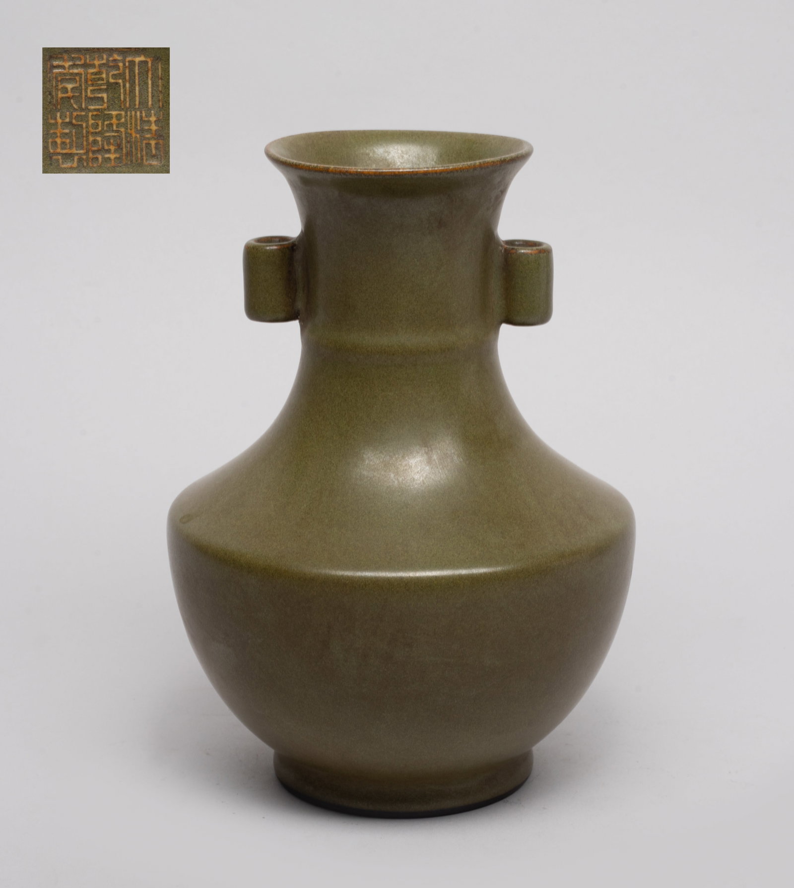 Estate Chinese Tea Dust Porcelain Vase: The ovoid body rising from a short foot to an angled shoulder and a cylindrical neck with flared rim, set with a pair of tubular handles, overall covered with tea dust glaze, the bottom inscribed with
