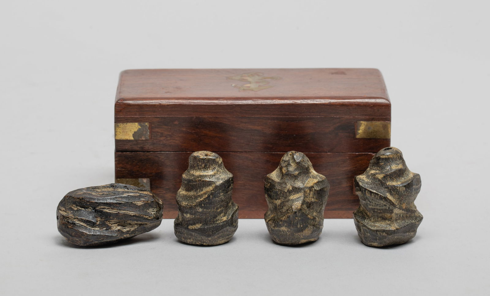 Estate Chinese Agarwood Beads: Set of four Chinese agarwood carved beads, with box. Approx. 33 gram (bead weight), 1.35*0.93*0.8 inch (largest bead).