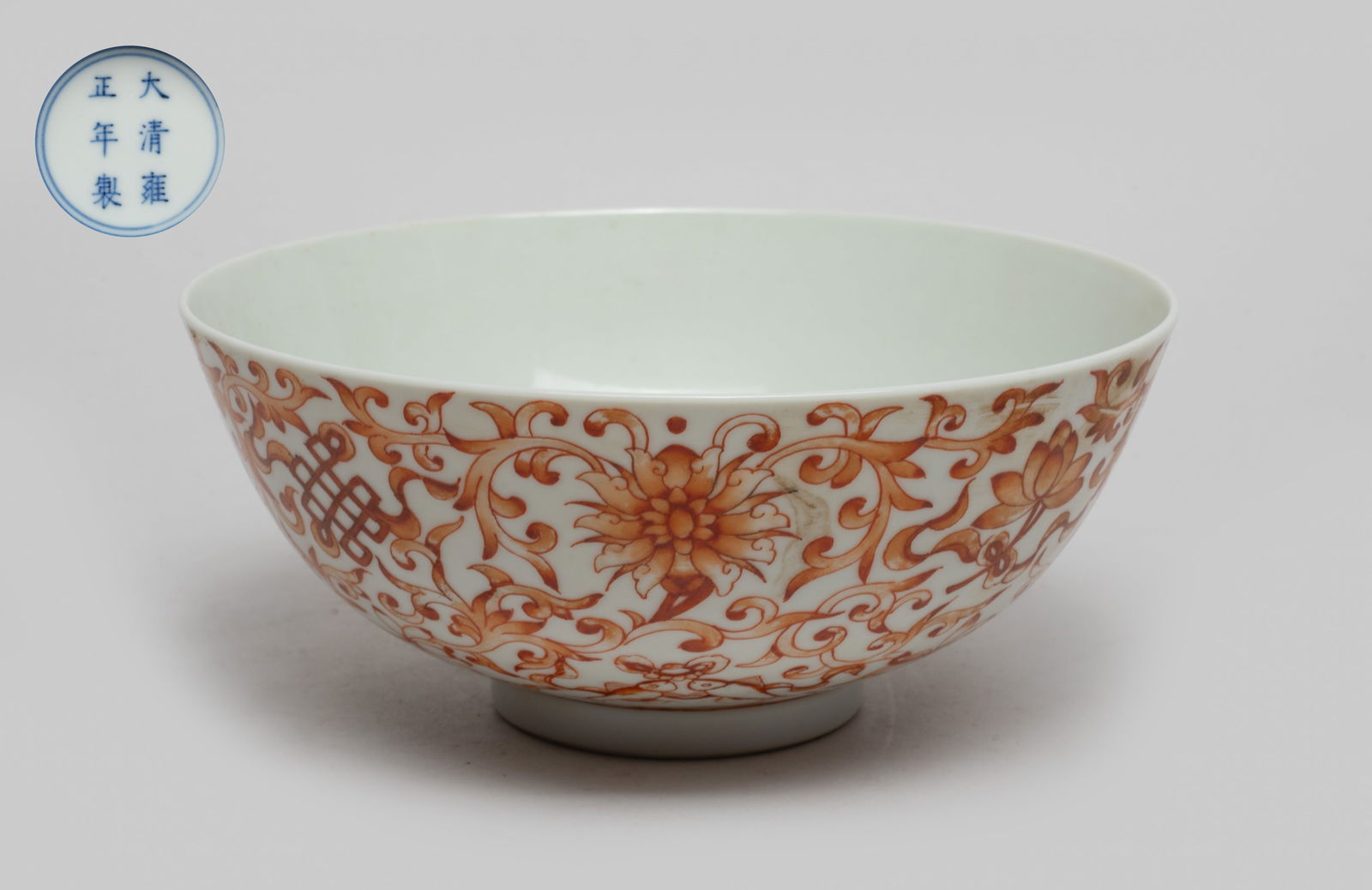 Chinese Export Porcelain Bowl: The bowl exterior painted with lotus foliage and Buddhist eight treasures in copper red, the bottom marked with six characters in blue enclosed in double circles. Approx. 5.9*2.5 inch.