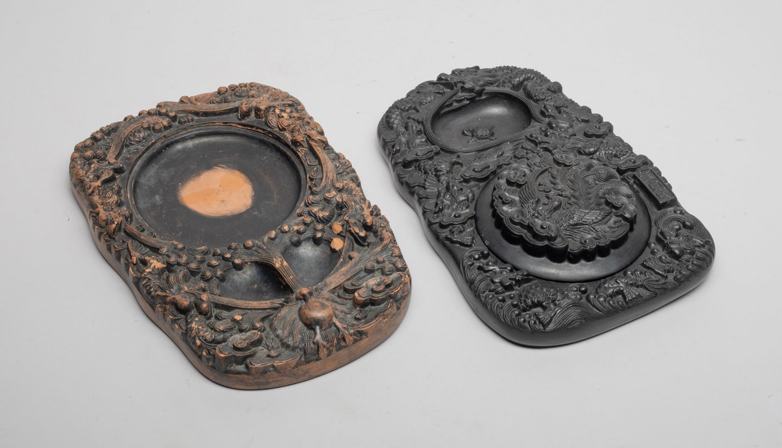 Two Chinese Large Writing Pieces: One carved with dragons amidst clouds, the smaller hollow carved with a turtle, the larger hollow with a lid carved phoenix amidst clouds, with a three-character mark, the other carved with dragons sp