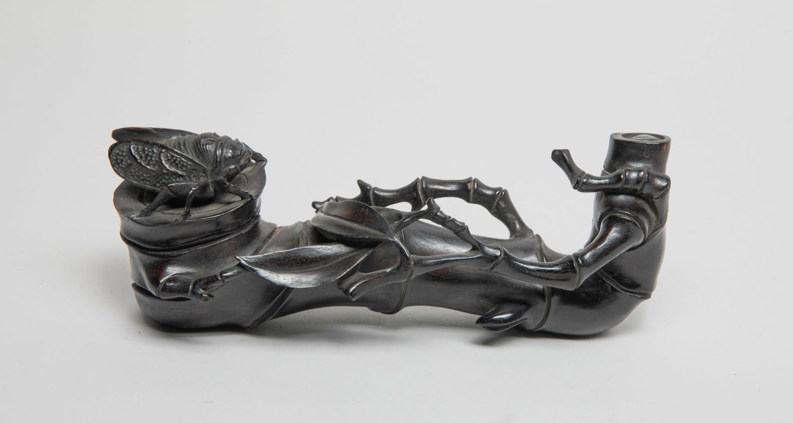 Chinese Zitan Like Wood Brush Stand: Naturalistically carved in form of bamboo, issuing further branches overflowing between the terminals, with a cicada resting on one side. Approx. 6.7*2.5*2.1 inch.