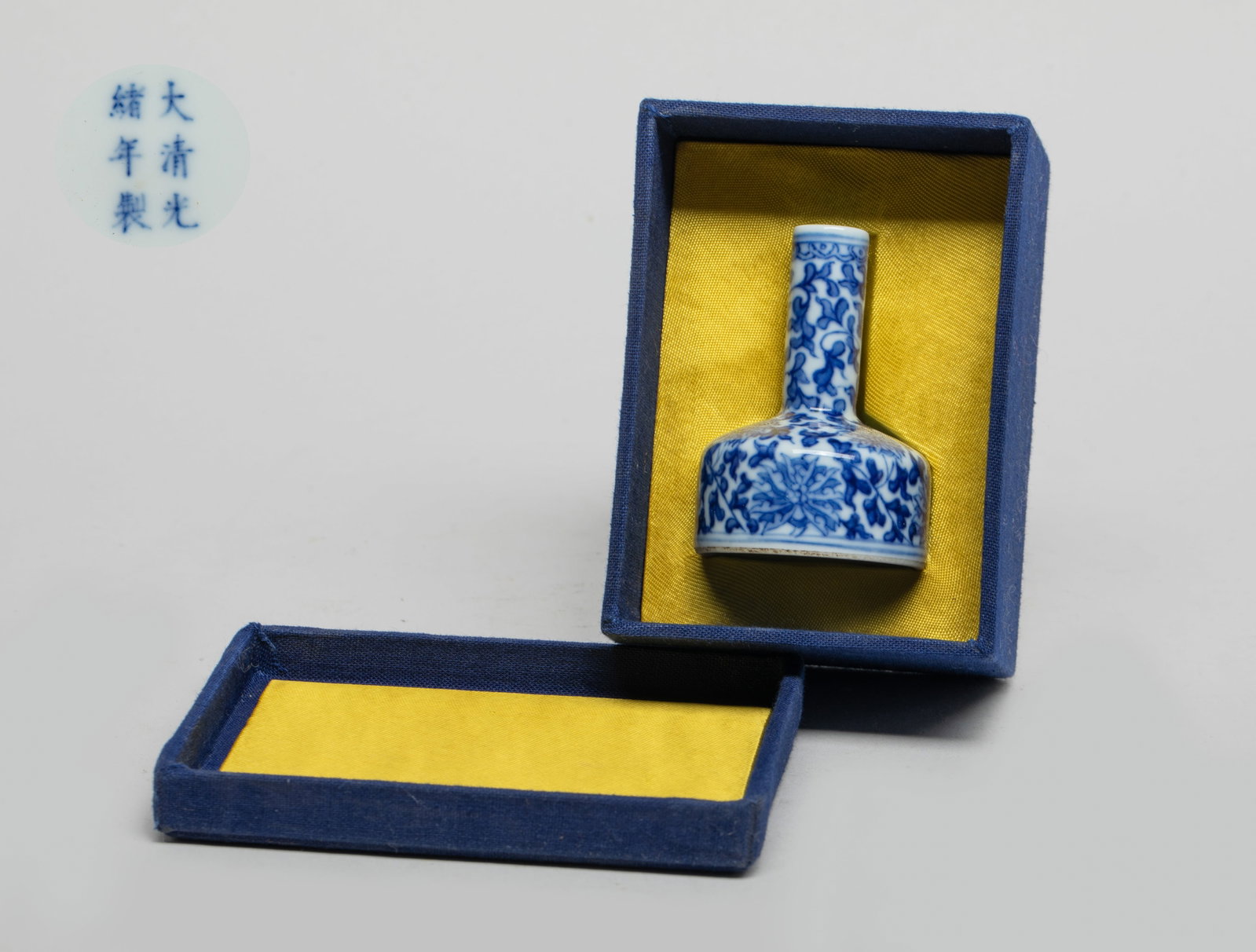 Chinese Blue & White Porcelain Bottle: Of compressed form with a cylindrical neck, the exterior painted with undulating leafy lotus foliage, the bottom marked with six characters, with box. Approx. 2.35*1.65 inch (w/o box).