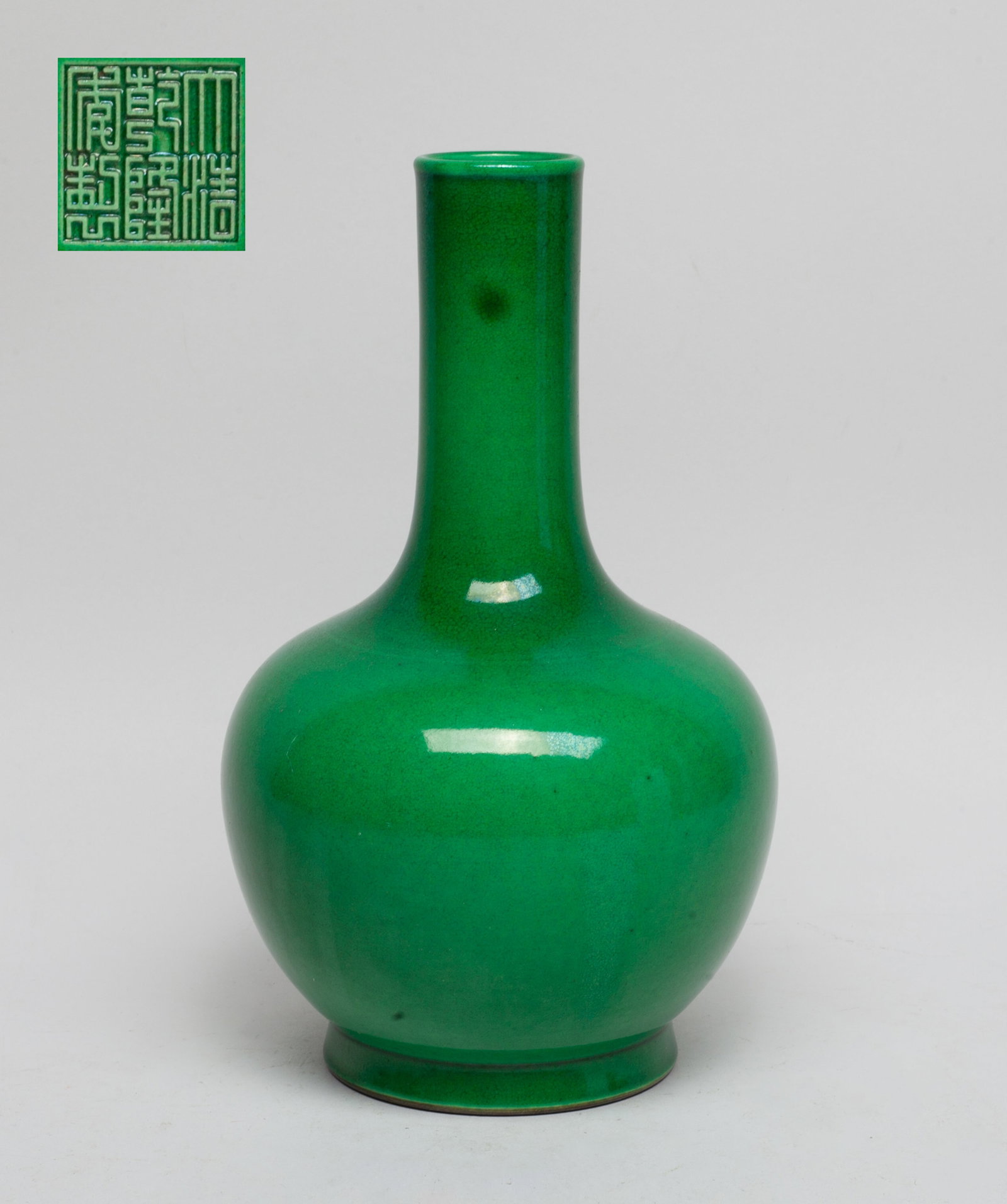 Chinese Turquoise Glazed Porcelain Vase: The ovoid body rising from a short foot to a cylindrical neck, the exterior covered with crackled turquoise-green glaze, the bottom inscribed with a six-character mark. Approx. 8.7*5.2 inch.