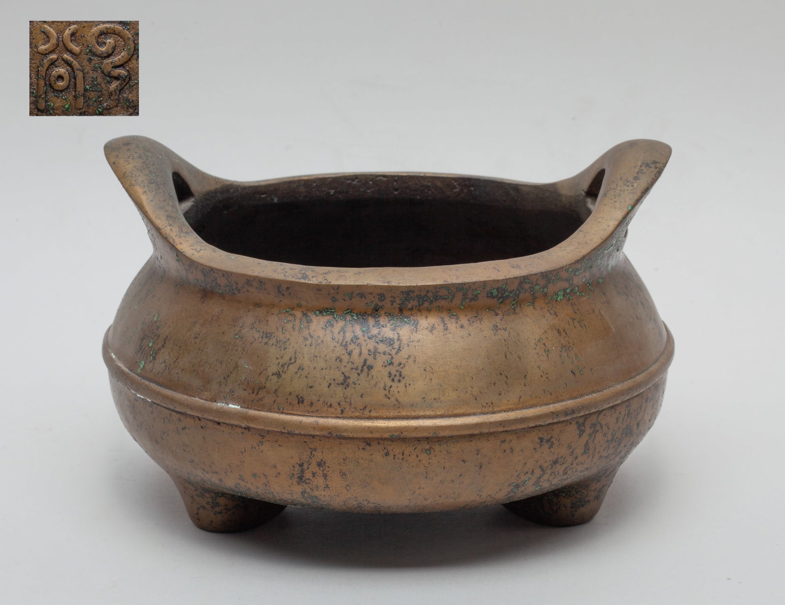 Chinese Bronze Cabinet Censer: Of compressed form with three short feet and two handles, the bottom carved with a seal mark. Approx. 6.4*4.1 inch.