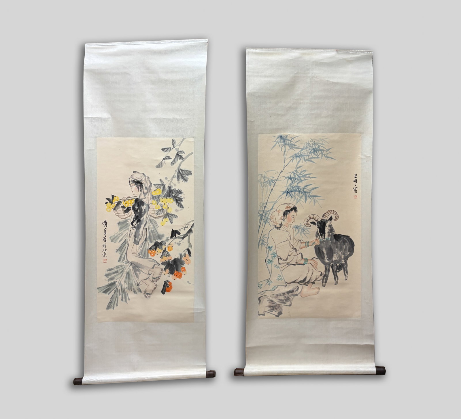 Estate Set Vintage Chinese Watercolor Paintings: Two Chinese watercolor paintings, one depicting a woman picking fruits, the other depicting a woman feeding a goat around bamboo. Approx. 39*20 inch (larger painting size).