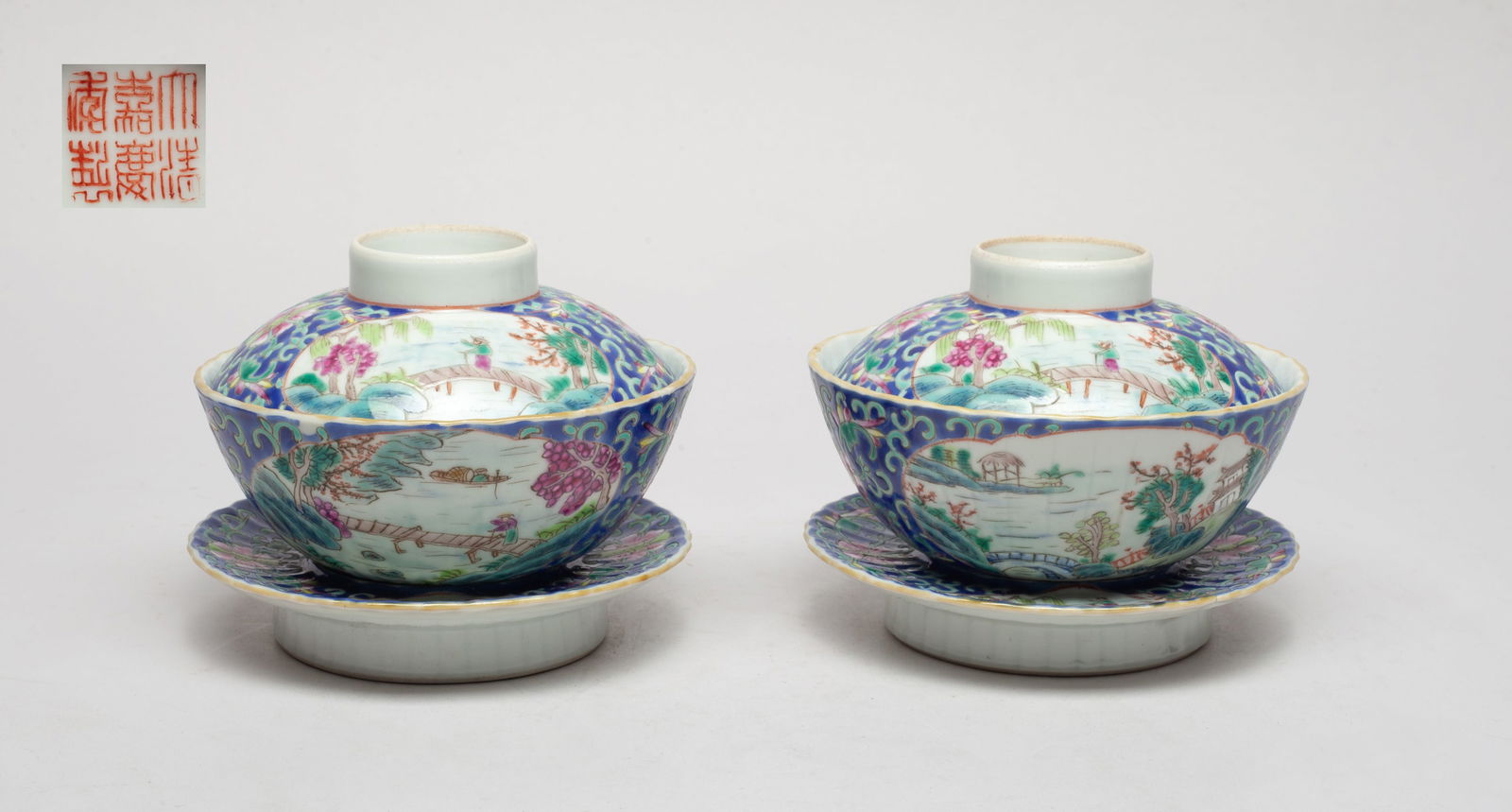Set Chinese Export Porcelain Tea Bowls: The tea cup, lid and base painted with medallions of a figure standing on a bridge over river among trees, against dark-blue glazed ground suffused with dense foliage, the lid centre and the cup botto