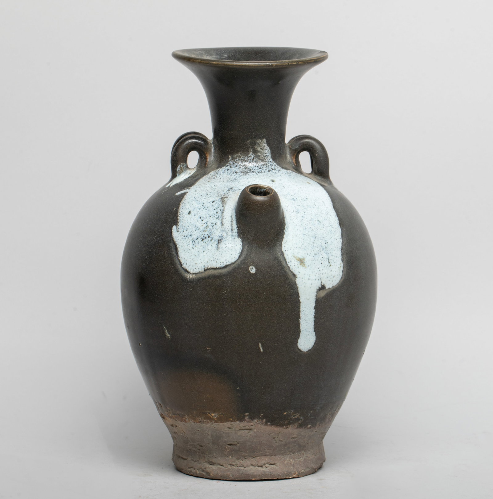 Chinese Jichou Ware Porcelain Pot: The ovoid body rising from a short foot to a gently waisted neck and a flared rim, covered in thick black glaze with white bubbled splashes, stopping above the unglazed foot. Approx. 9.8*6 inch.