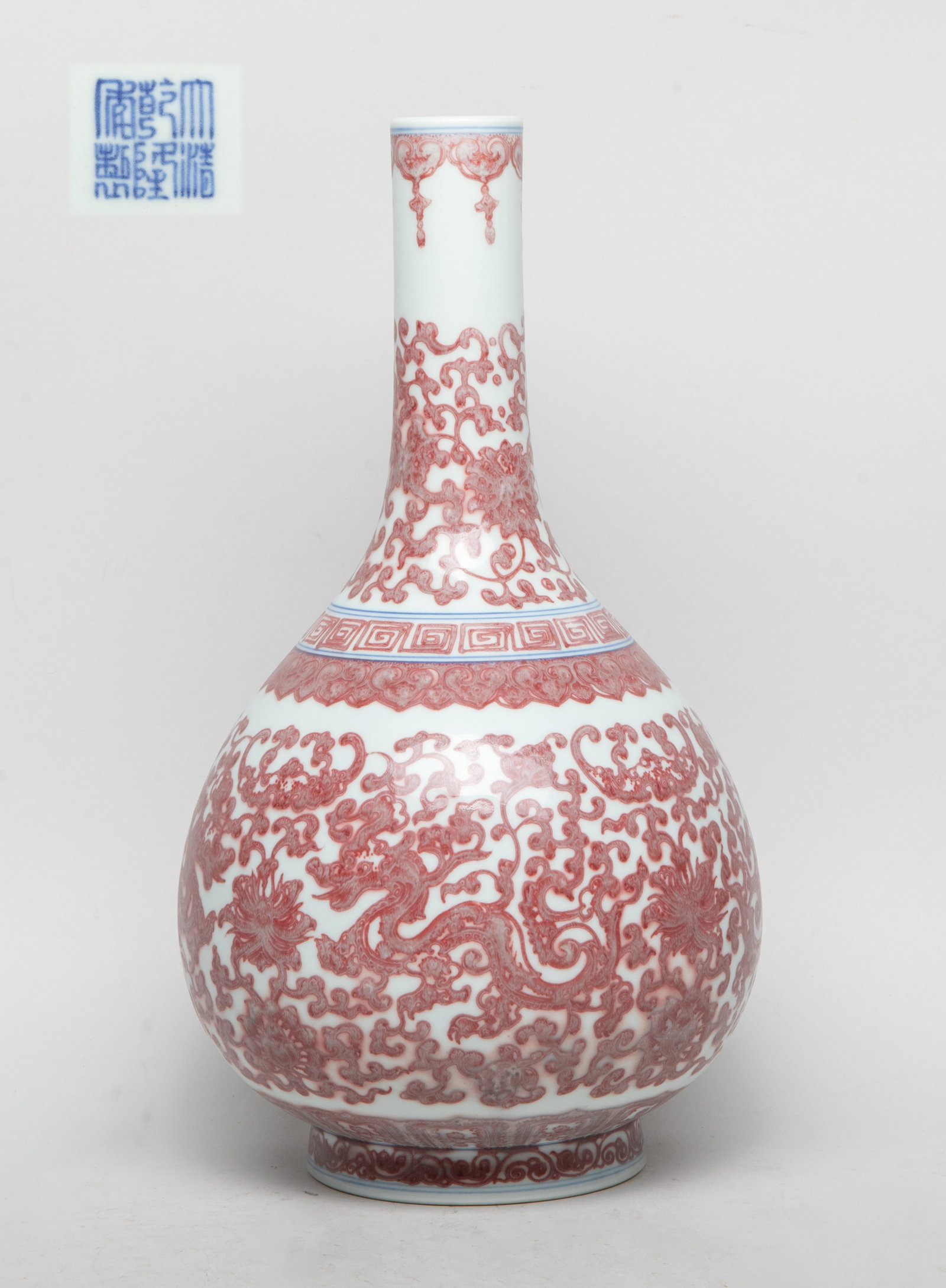 Collectible Chinese Export Porcelain Vase: The pear-shaped body rising from a short foot to a tall slender neck, the exterior decorated with bats, sinuous dragons, and dense foliage scrolls, the bottom inscribed with a six-character mark. Appr