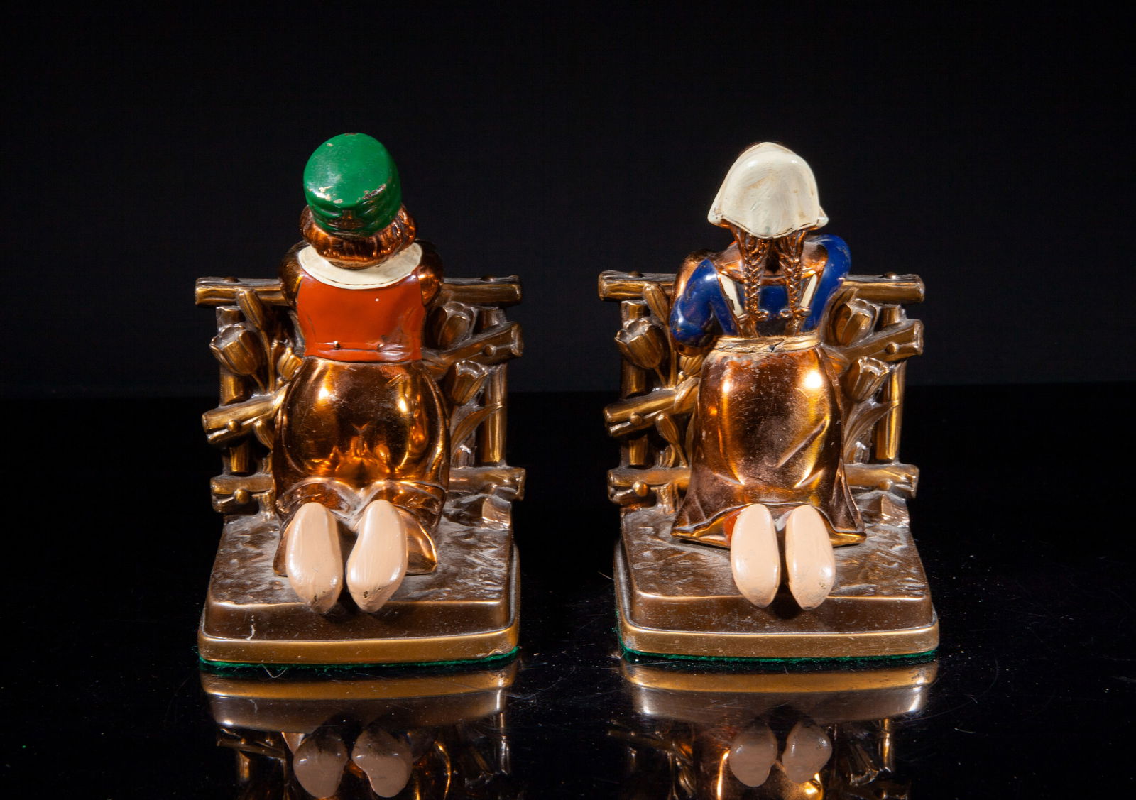 Two 1900-30s Painted Bronze Bookends: Two vintage painted bronze bookends, moulded as a boy or a girl kneeling along flower fence and looking forward. Approx. 5.5*4*3.9 inch (larger). The Estate of the Huntington Beach, CA, 1999.