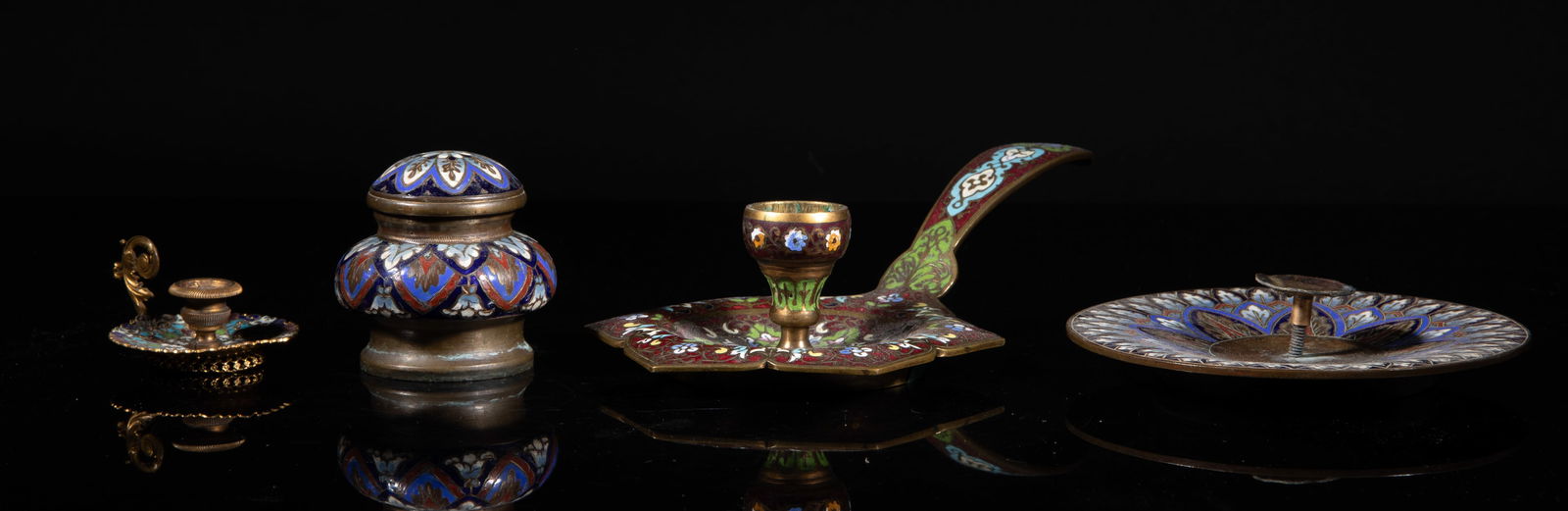 Set Antique France Enameled Brass Wares: Set of three antique France brass candlestick holders, each enameled with delicate floral motif, wherein one with a candle snuffer. Approx. 7.5*3.7*1.7 inch (largest). The Estate of the Moving Sale, H