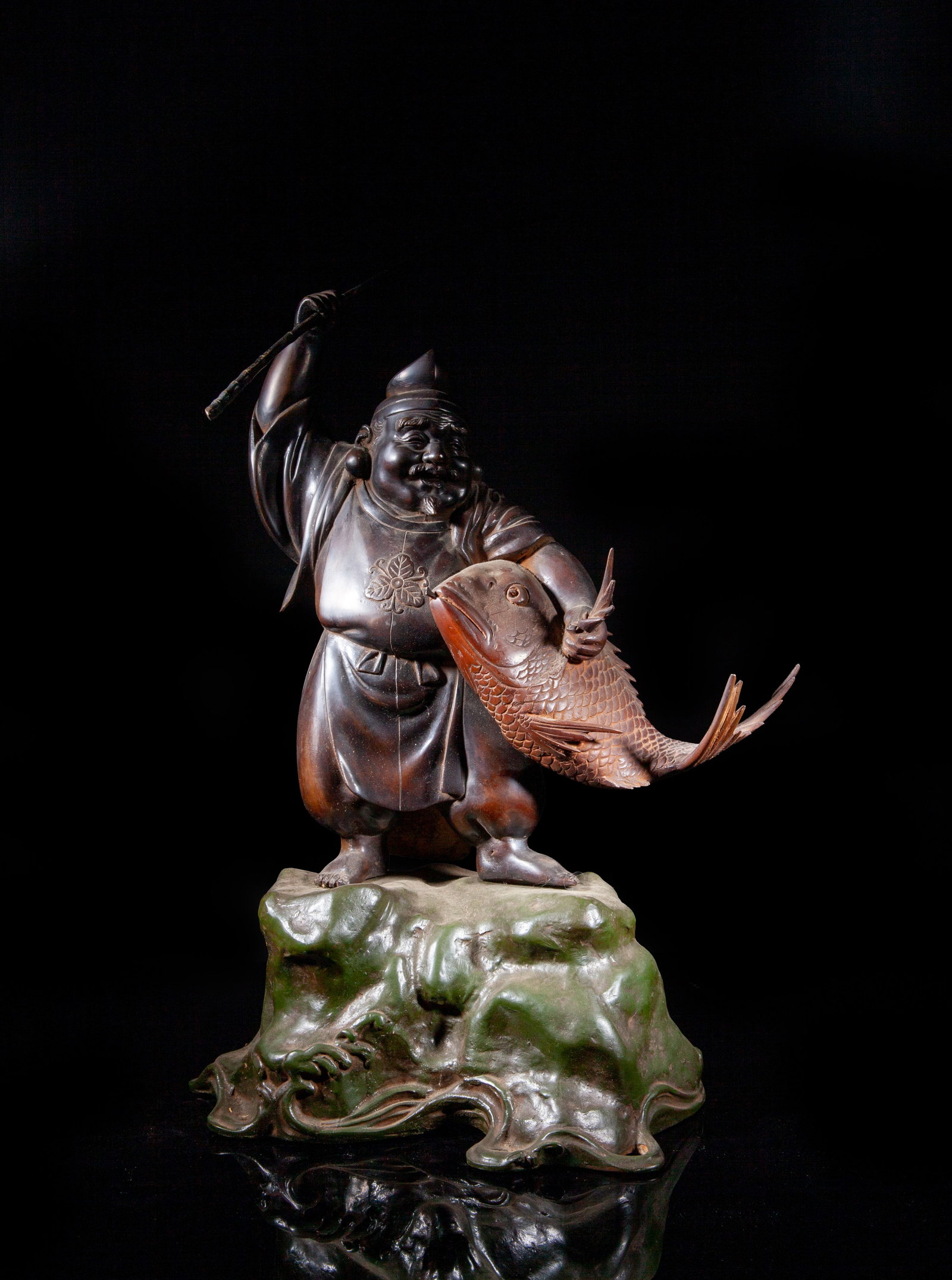 Large Japanese Late Meiji Metal Sculpture: Large heave Japanese metal sculpture, cast as a fisherman with a big fish under his arm, holding a long stick in his left hand and grasping the fish scales with his right hand. Approx. 19*11.5*8 inch.