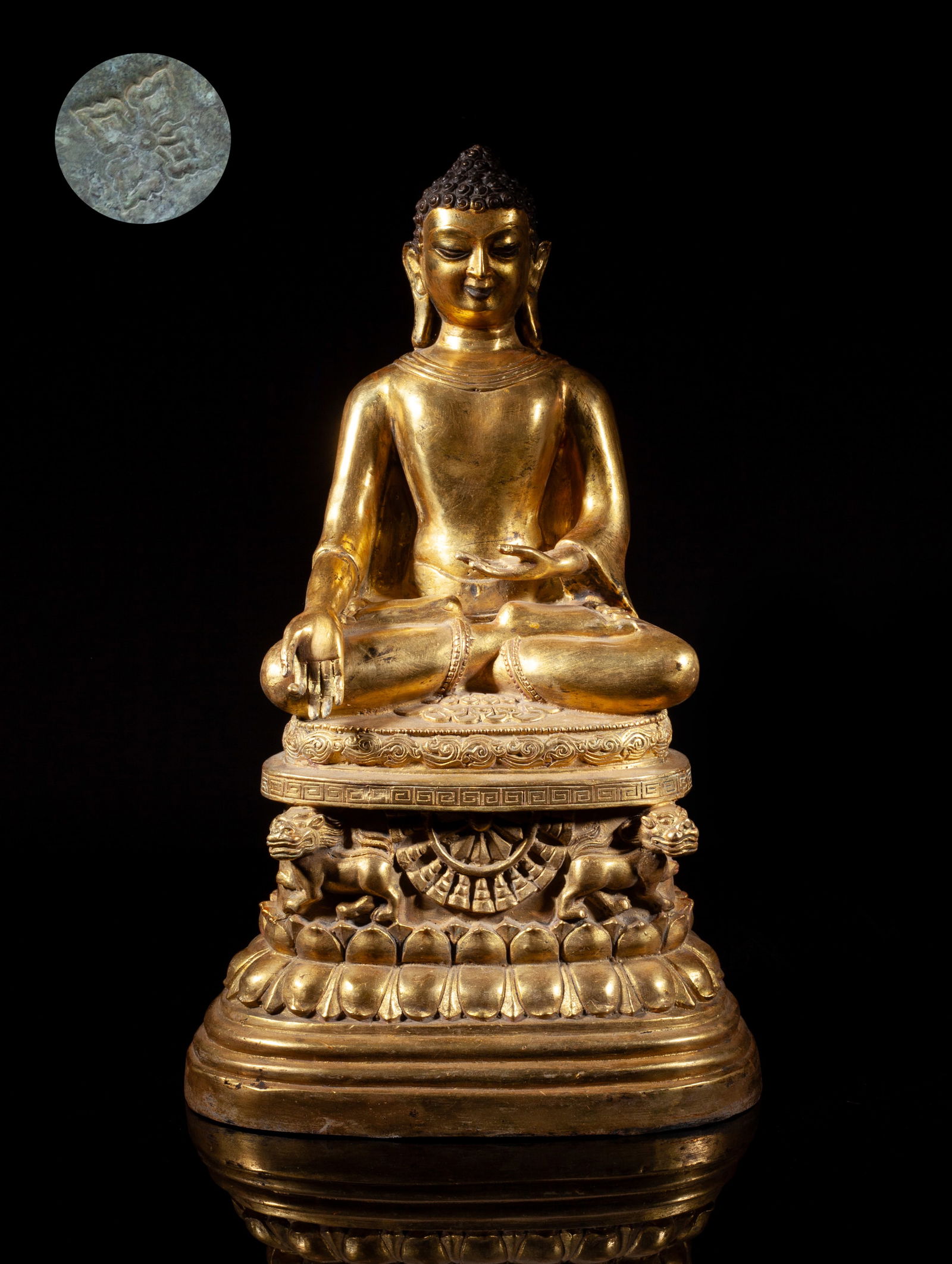 Chinese Gilt Bronze Tall Buddha: The Buddha sits dhyanasana on a tall lotus plinth cast with two beasts, the hands in varada mudra, with tight hair spirals, full face, and pendulous earlobes, attired in the loose garments of a monk.