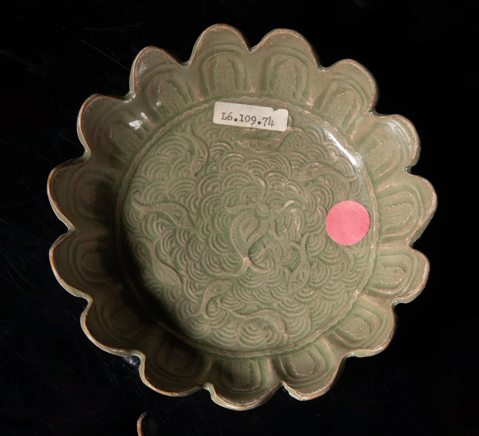 Estate Chinese Yaochou Porcelain Lotus Plate: Molded of floral form, the interior centre carved in low relief with fish swimming over waves, the sides carved with petals, overall covered with bubbled olive-green glaze. Approx. 6*1.7 inch. The Est