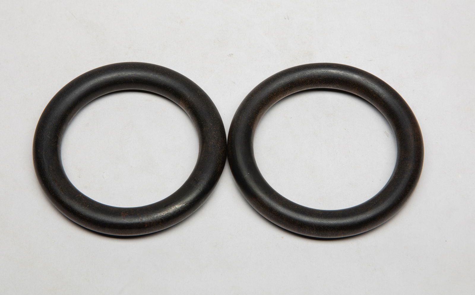 Two Chinese Agarwood Bangles: Two Chinese agarwood bangles. Approx. 3.36 inch outer diameter, 2.36 inch inner diameter (larger), 60 gram (total weight).