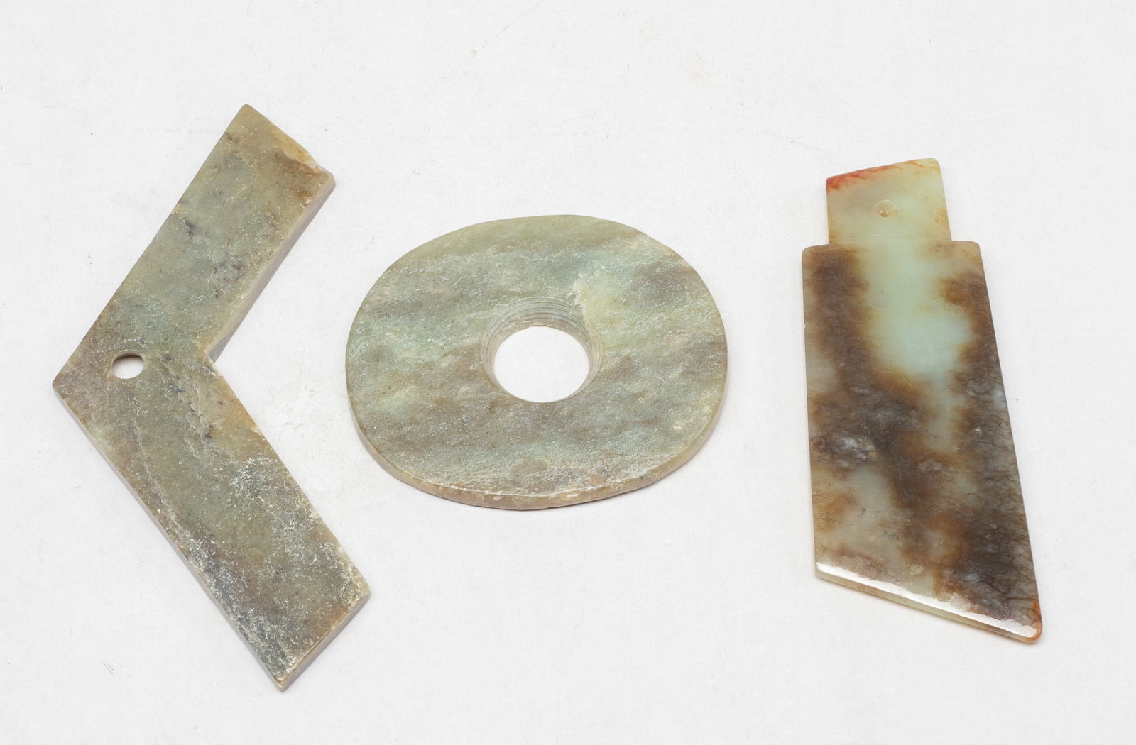 Estate Set Chinese Jade Axe, Bi, Pendant: Three Chinese russet jade carvings, including a bi, an axe, and a special shape pendant. Approx. 5.17*1 inch (largest). The Estate of the Store Closed Sale, Little Tokyo, LA, 2021.