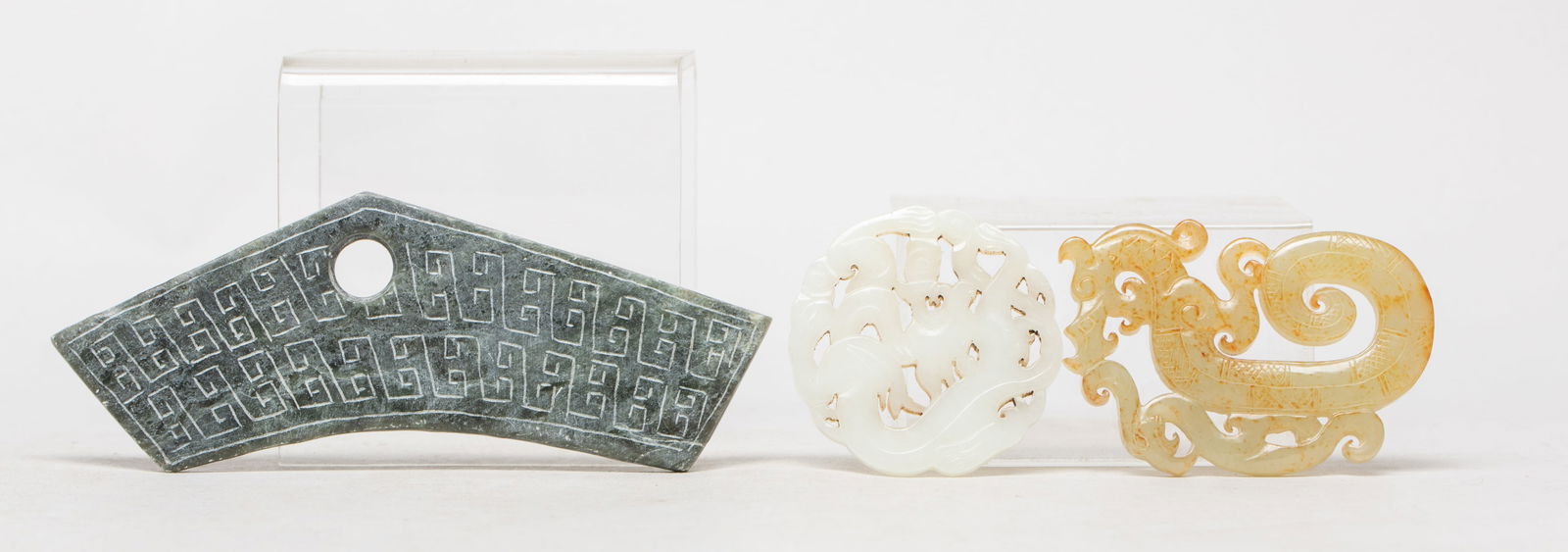 Estate Set Chinese Jade Carvings: Three carvings as a group, one carved in openwork as a sinuous beast, one carved as a coiled dragon with a bird along its body, the other worked of archaic musical form. Approx. 5.3*1.78 inch (largest