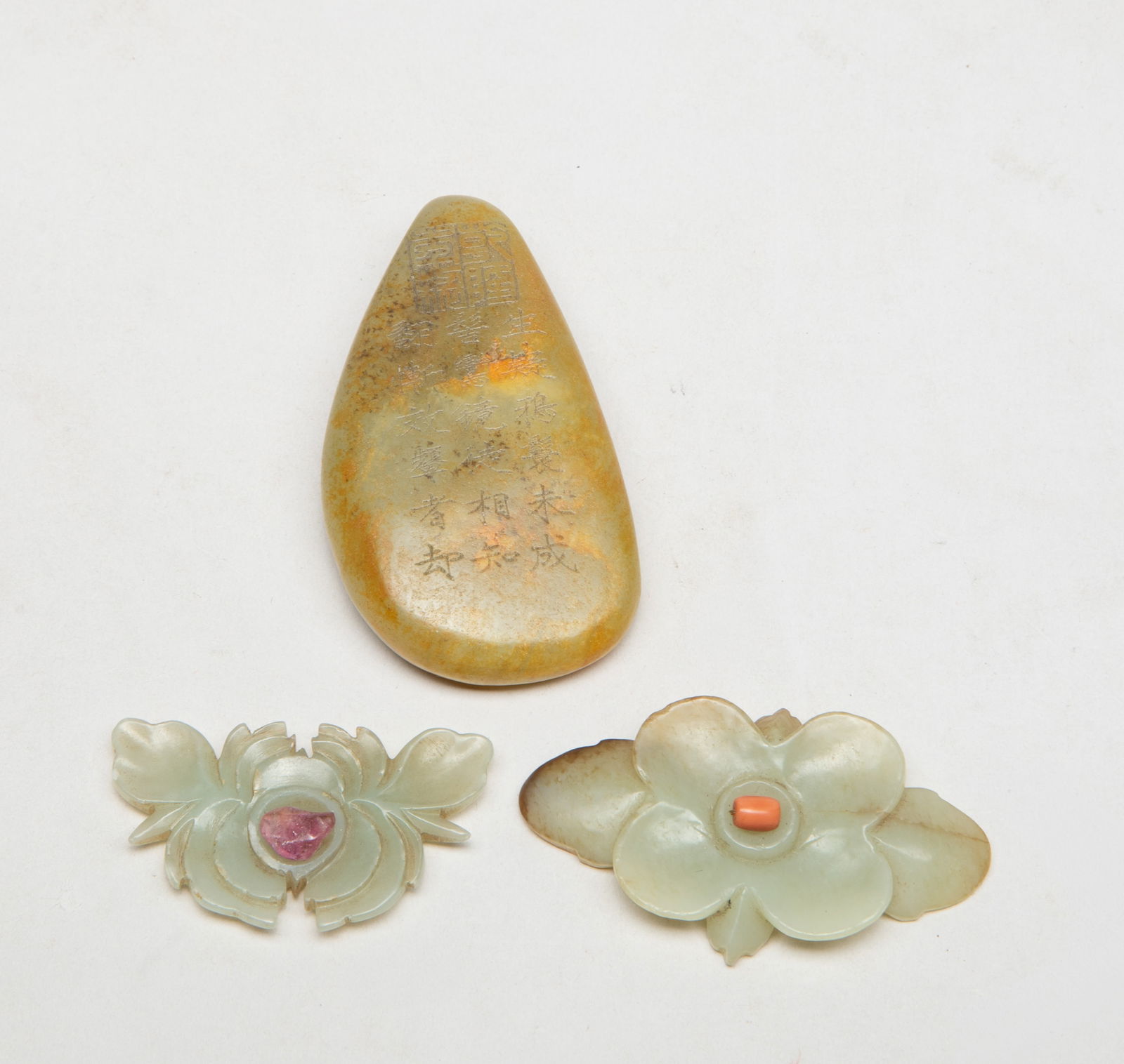 Estate Chinese Jade Pendants Set: Including a russet jade pebble, incised with poems and a seal mark, and two jade carvings of flower form, inset with gemstone at the centre. Approx. 3.05*1.7*0.65 inch (largest).