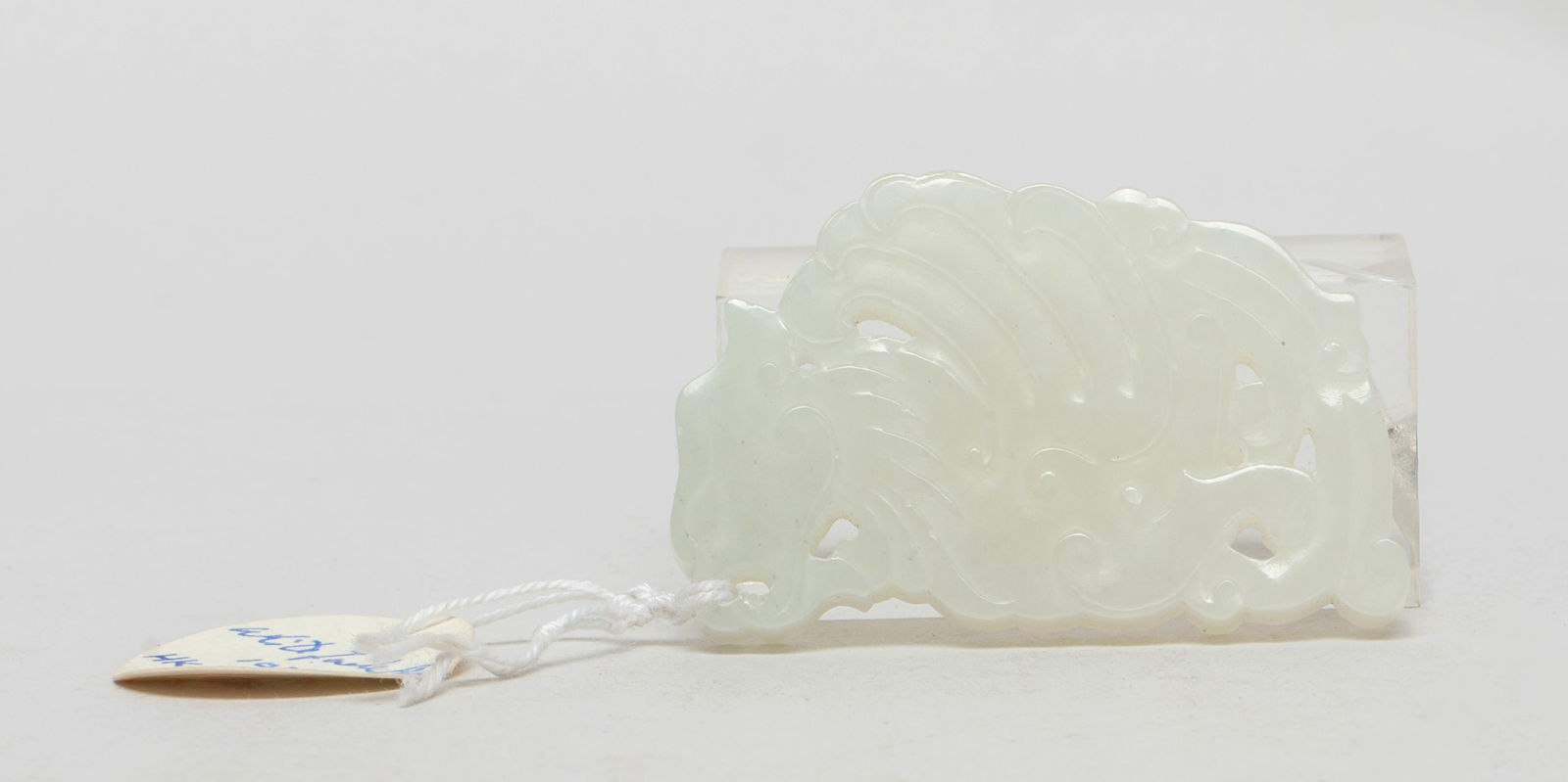 Estate Chinese White Jade Pendant: Chinese white jade pendant carved and reticulated as a stylized phoenix above clouds. Approx. 2.1*1.3 inch.