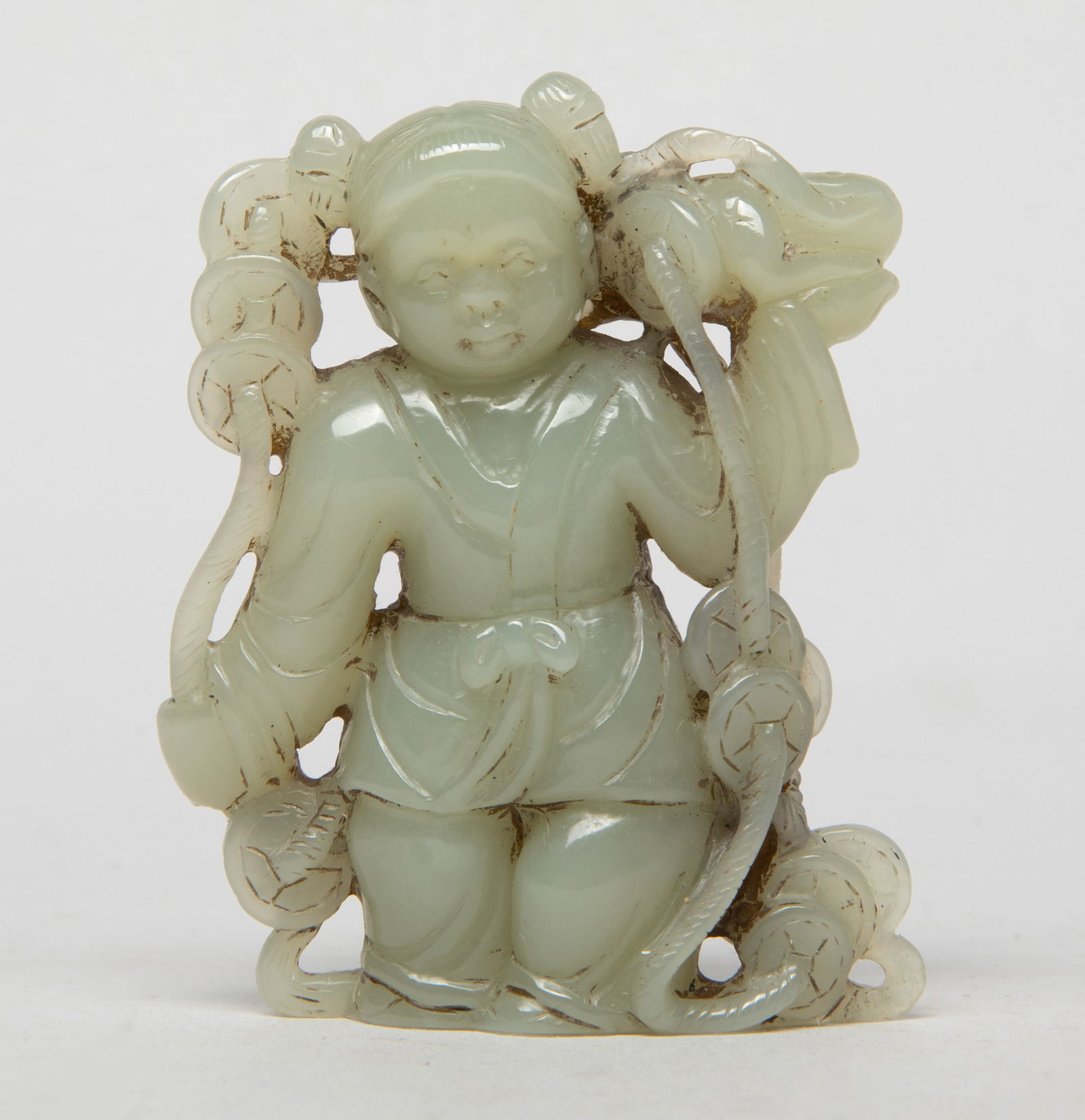 Estate Chinese Jade Figure Sculpture: Chinese pale celadon jade sculpture, skillfully carved as a standing boy grasping a long string of coins in hands. Approx. 3*2.3*0.9 inch.