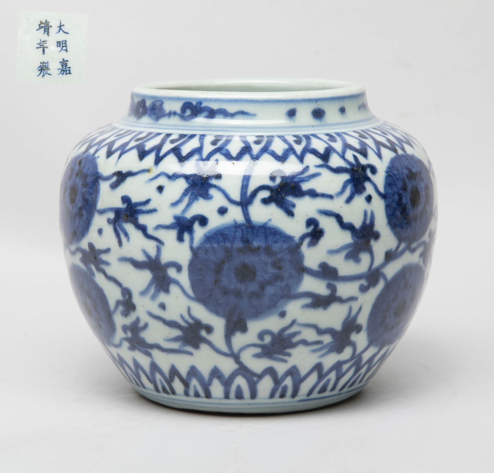 Estate Chinese Blue & White Porcelain Jar: The ovoid body exterior painted with undulating floral scrolls between bands of overlapping petals, the bottom marked with six characters. Approx. 5.9*4.9 inch.