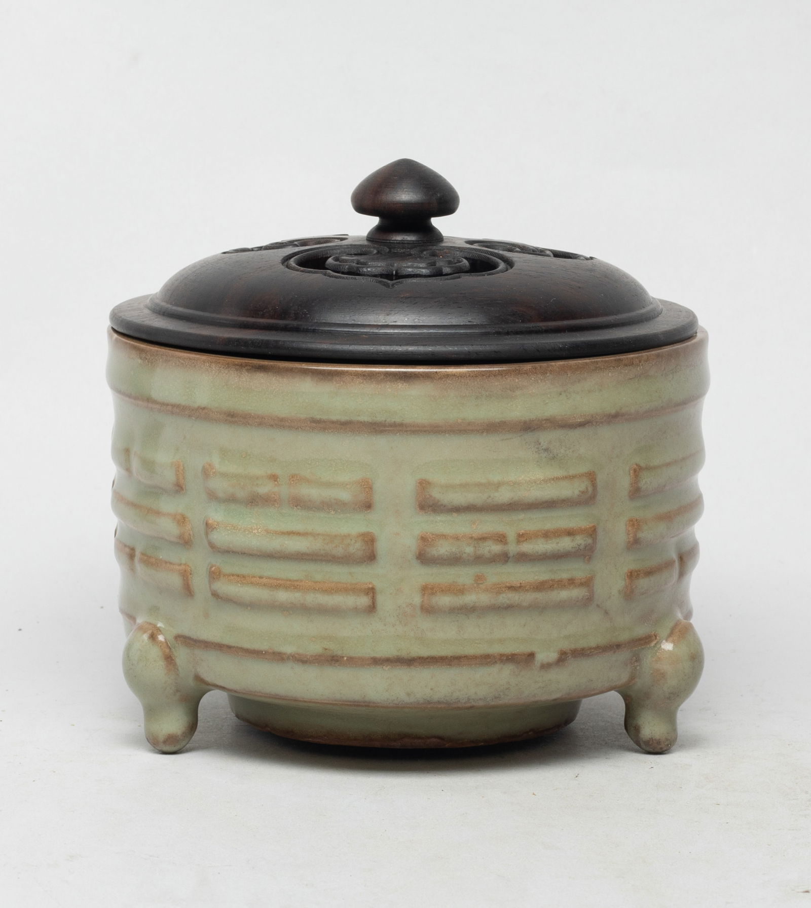 Estate Chinese Longquan Porcelain Censer: Of cylindrical form with three short feet, the exterior carved in raised relief with Daoist Eight Trigrams, overall covered with mottled celadon glaze save for the unglazed foot, with an openwork wood