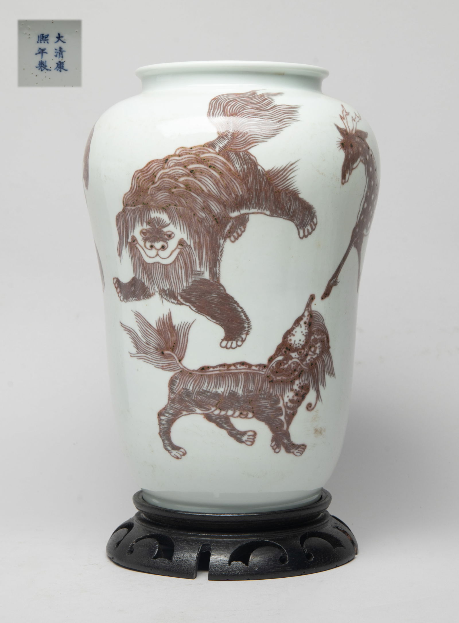 Tall Chinese Copper Red Glazed Porcelain Vase: The vase exterior painted with five mythical beasts in dark copper red, the bottom marked with six characters in blue glaze, with stand. Approx. 10.2*7 inch (w/o stand).