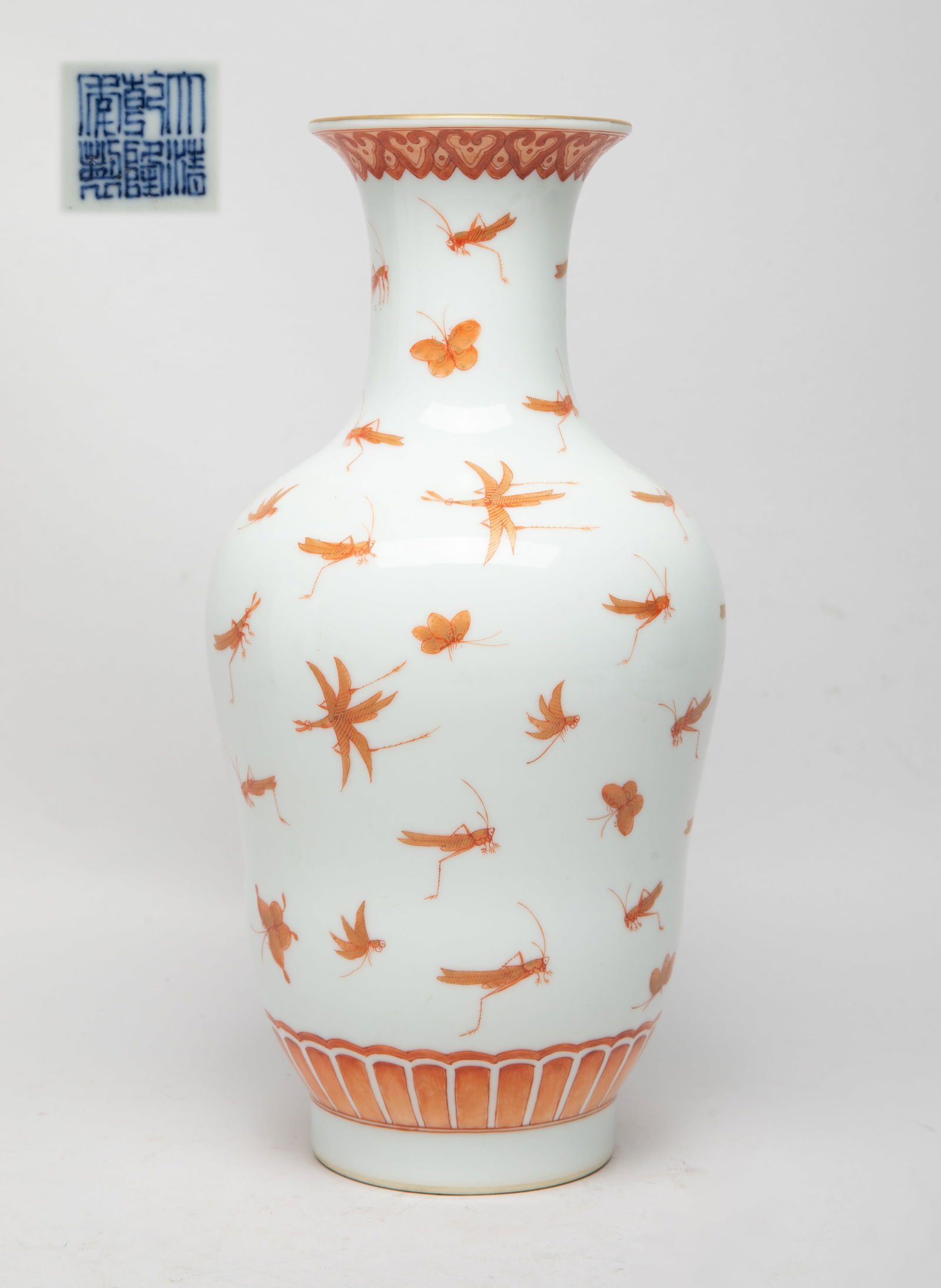 Chinese Porcelain Cabinet Vase: The vase exterior decorated in copper red with butterflies and grasshoppers between bands of ruyi heads and lappets, the bottom with a six-character mark in blue glaze. Approx. 10.9*5.3 inch.