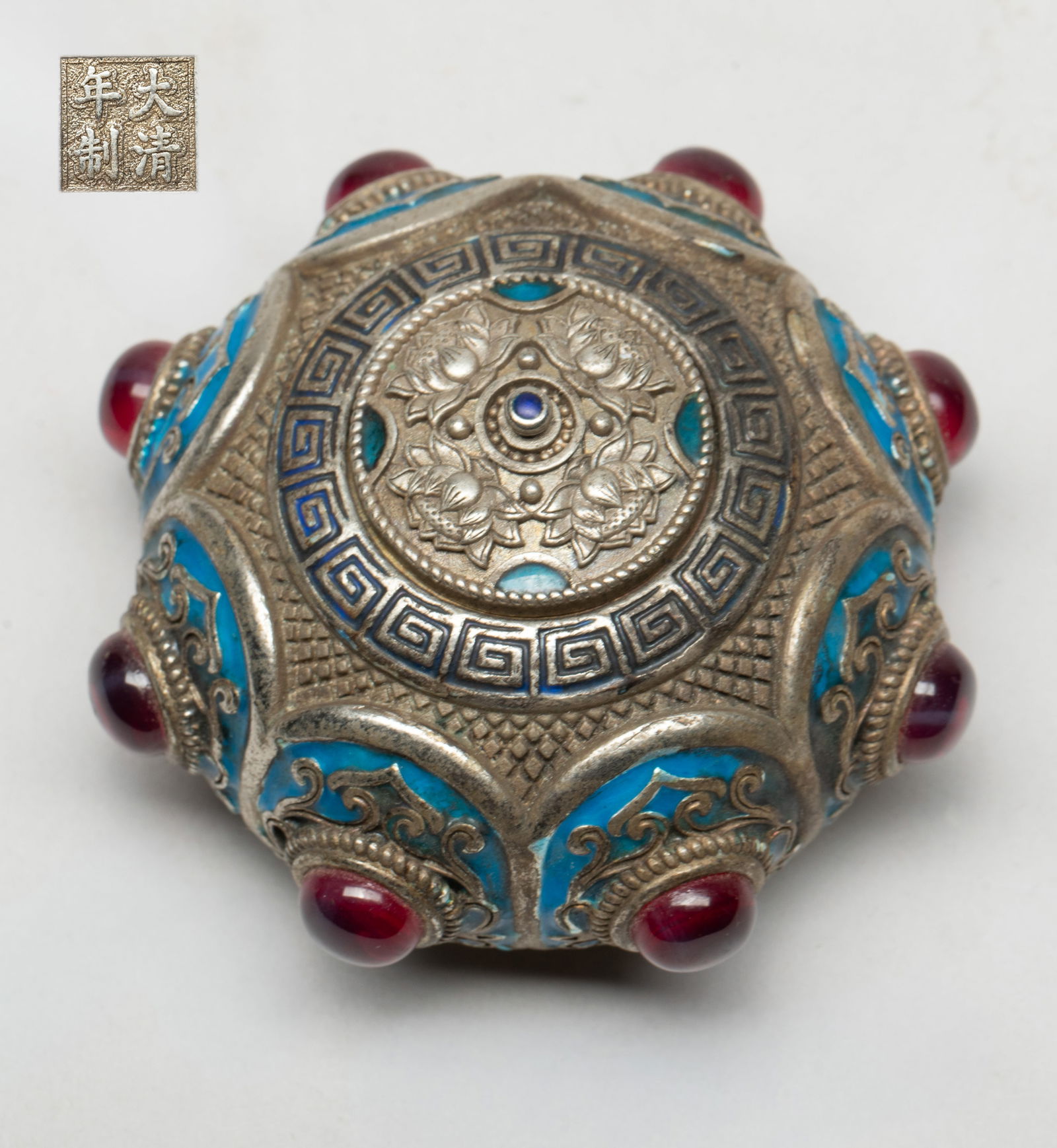 Chinese Export Enameled Jar: Of compressed globular form, the body cast and enameled with oval-shaped medallions inlaid with glass, the lid cast with four lotus blooms, the bottom inscribed with a four-character mark. Approx. 2.9