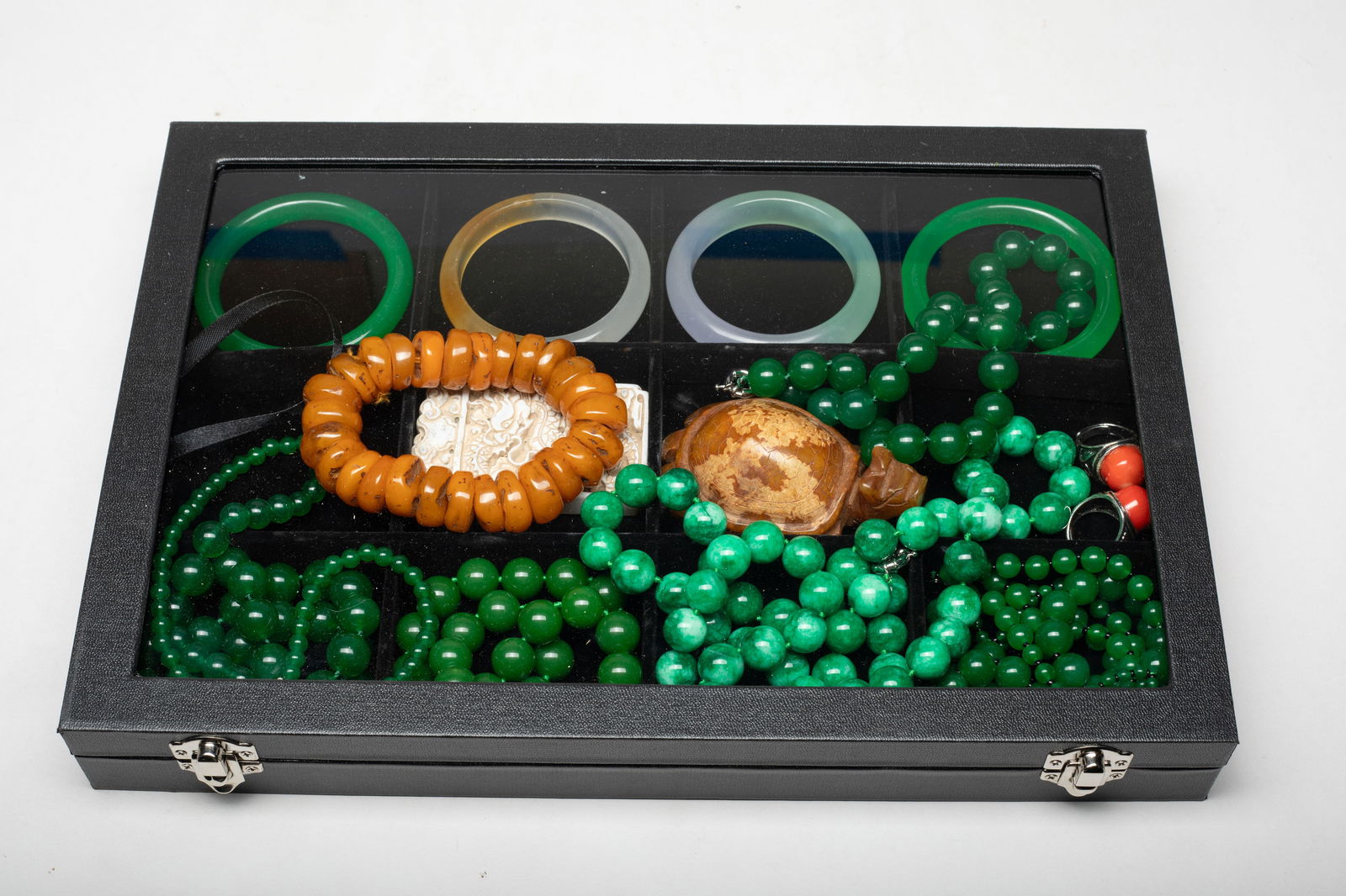 Set Chinese Export Colored Stone, Jewelry: Including colored stone bead necklaces, bangles, rings, a bead bracelet, a turtle sculpture, and a plaque carved with sinuous dragon on both sides, with case. Approx. 3.15*1.9 inch (plaque size).