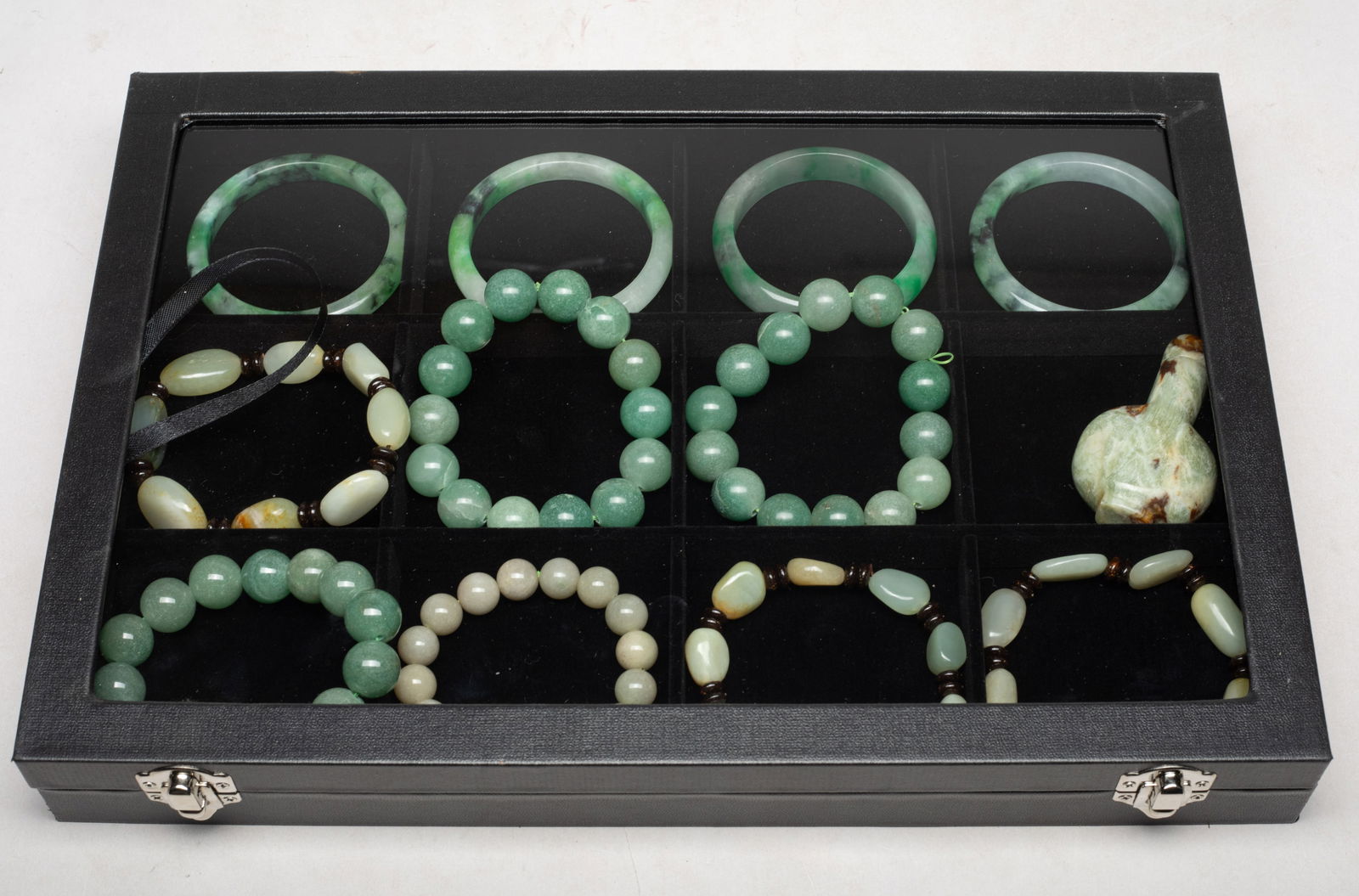 Estate Box of Chinese Jade/ Stone Beads, Carvings: Including four bangles, seven bead bracelets, and a snuff bottle, with case. Approx. 2.9 inch outer diameter, 2.3 inch inner diameter (largest bangle).