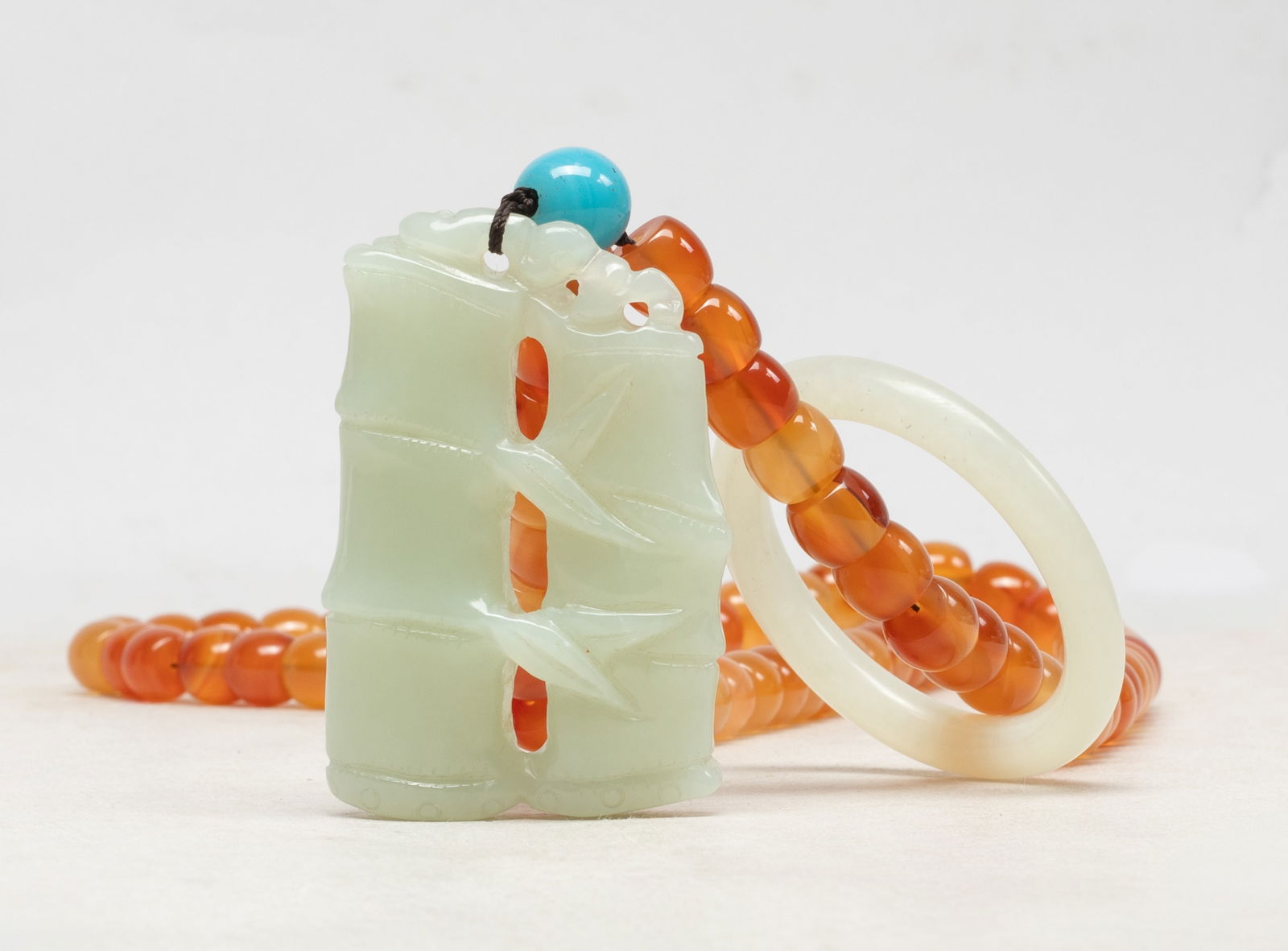 Rare Chinese Agate Necklace w/ Jade Pendant: A collectible agate bead necklace, with a jade huan, a jade toggle carved of bamboo form with a bat on the top, and a stone bead. Approx. 2.55*1.7 inch (jade toggle size).