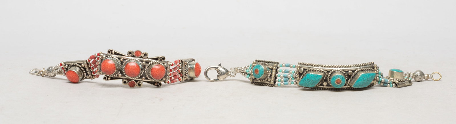 Two Chinese Tibetan/ Nepal Bracelets: Two Chinese Tibetan / Nepali bracelets, decorated with red-color and turquoise-color stone. Approx. 7.2 inch L (longer). The Estate of the Store Closed Sale, Hollywood, CA, 2019.