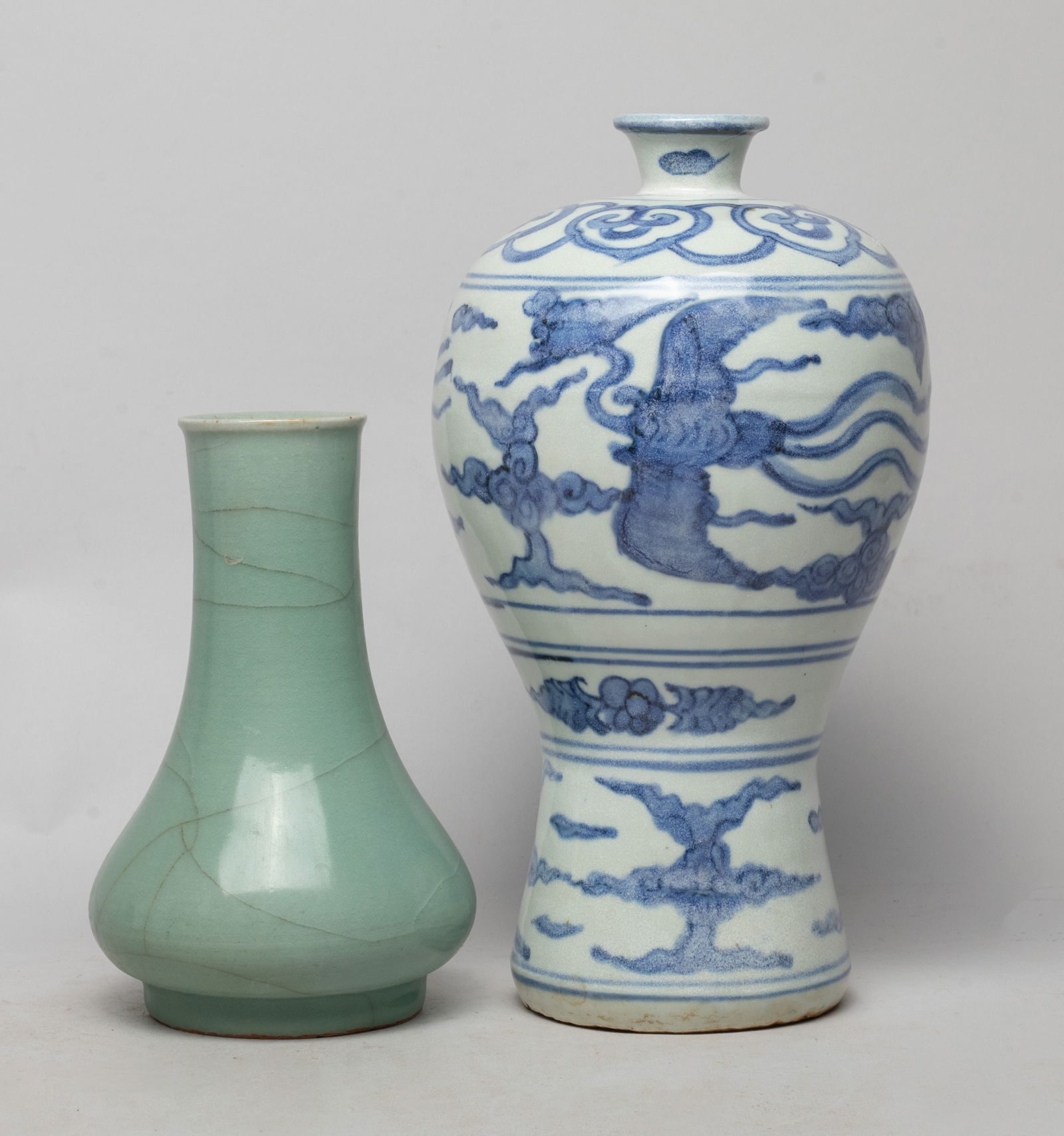 Two Chinese Export Porcelain Cabinet Vase: One vase overall covered with crackled celadon glaze, the other vase exterior painted with two phoenixes amidst clouds, under a band of ruyi heads, above two bands of flowers and clouds. Approx. 10.2*